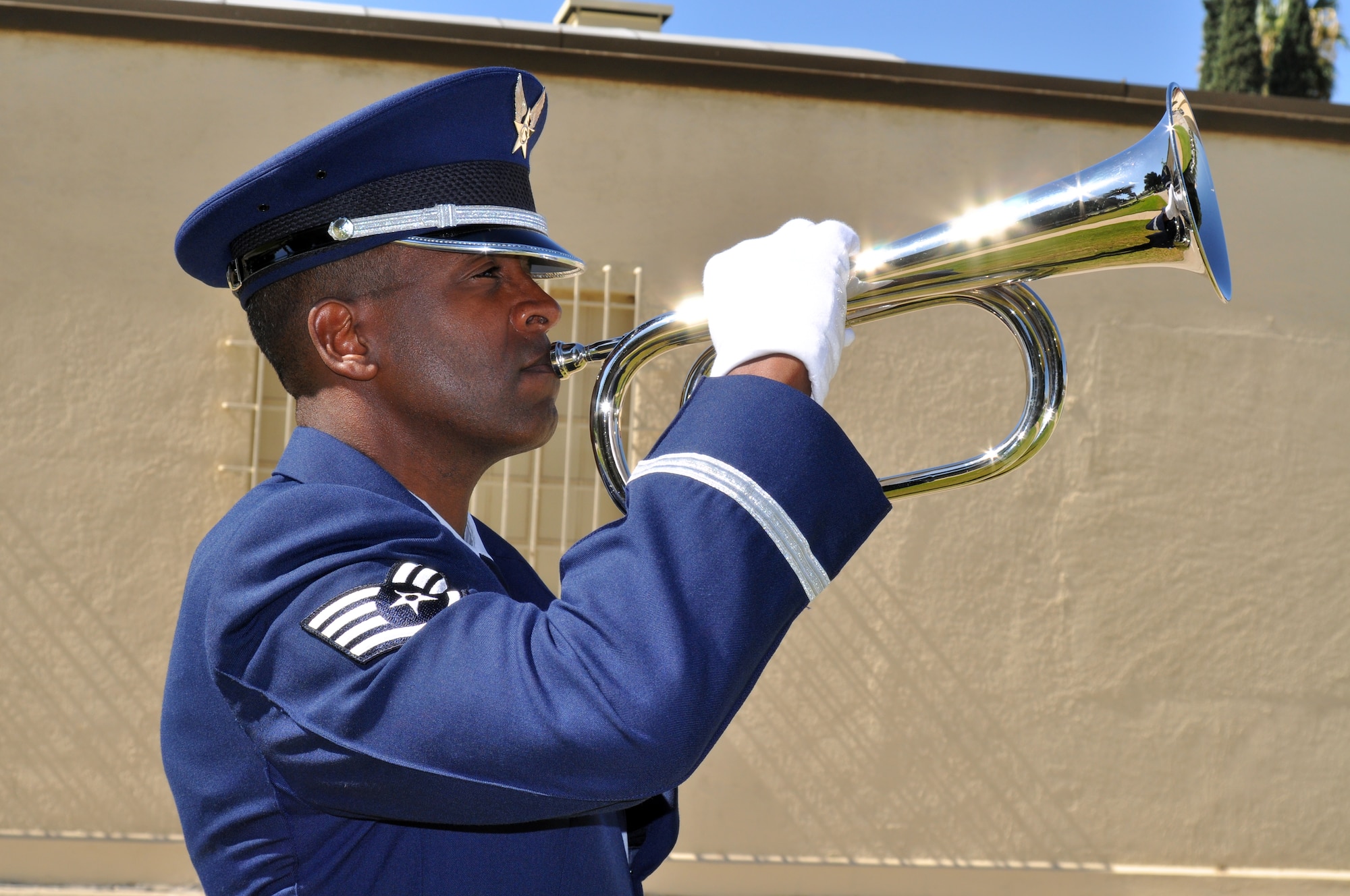 Staff Sgt. Dejon Fruga, Blue Eagles Total Force Honor Guard, plays “Taps” on his bugle at the end of the ceremony.  (U.S. Air Force photo by Linda Welz)
