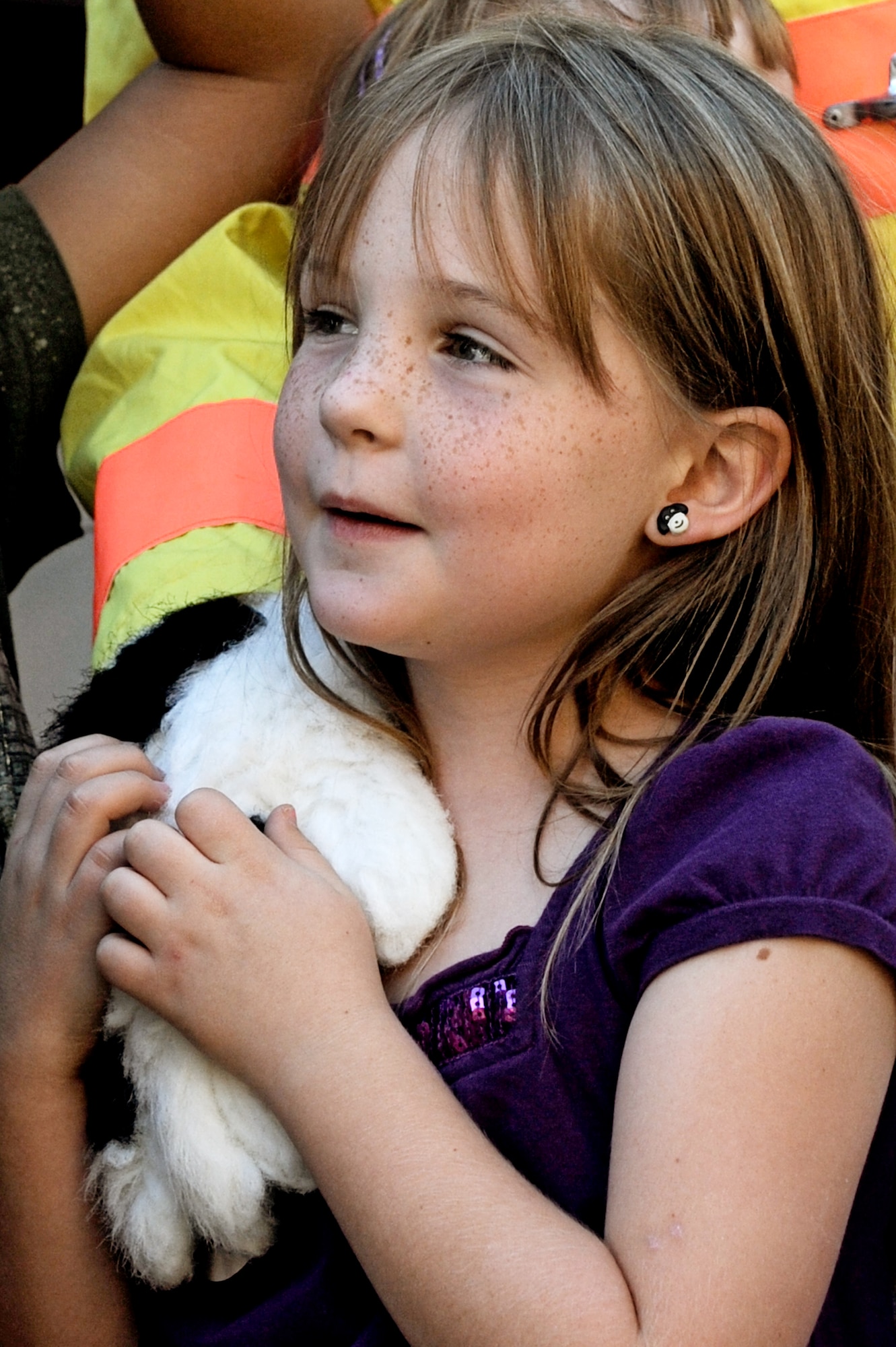 A child from the Youth Center holds on to Sparky the Fire Dog's paw Oct. 5. In honor of Fire Safety Awareness Week, the Scott Air Force Base Fire Department will provide fire safety awareness education and training throughout the week of Oct. 3-9. (U.S. Air Force photo/Staff Sgt. Brian J. Valencia)