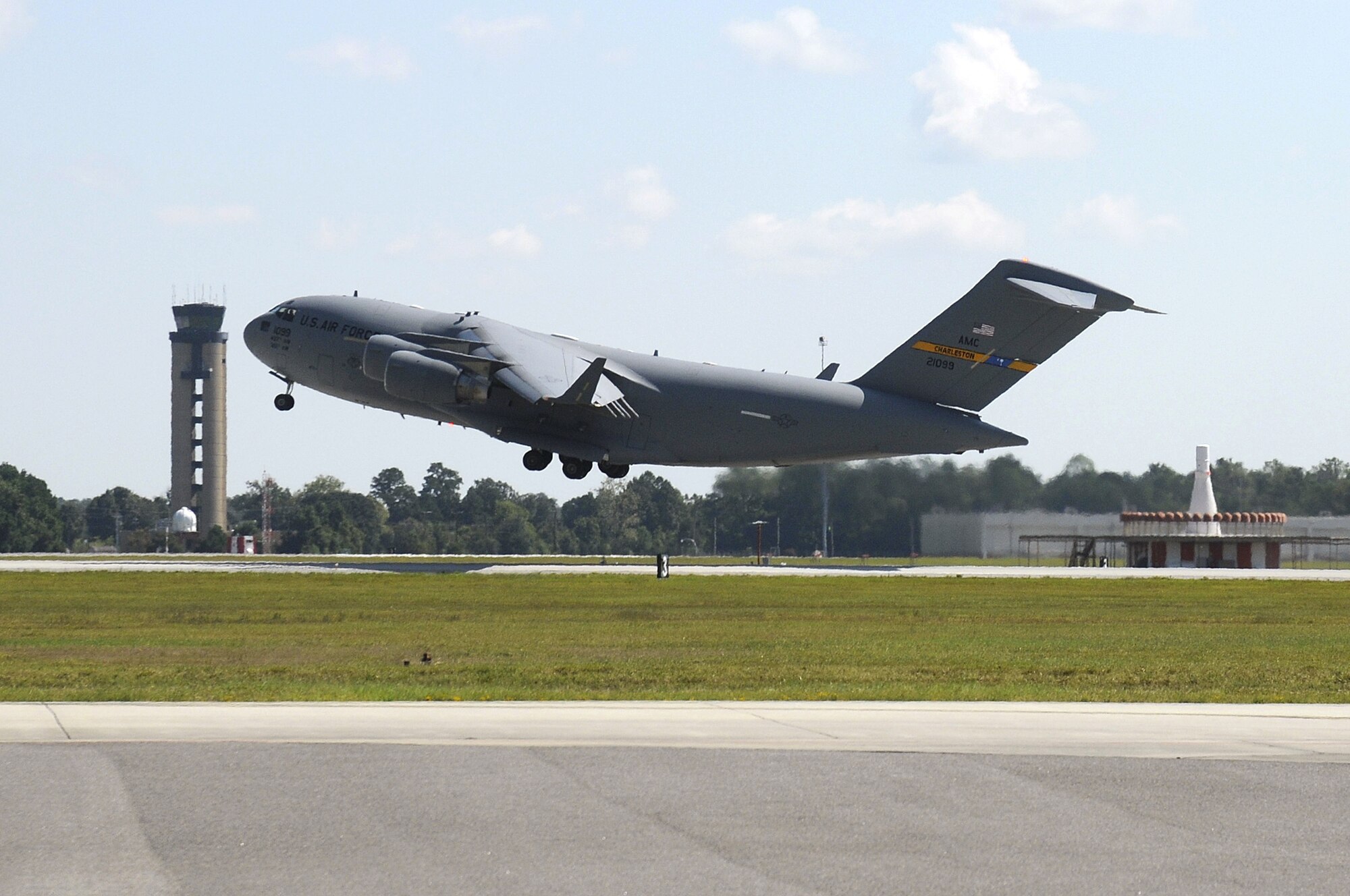 A Charleston C-17, trail number 21099, takes off after receiving maintenance from the 437th Aircraft Maintenance Squadron onboard Joint Base Charleston-Air Base. The squadron is comprised of more than 800 personnel that perform maintenance on more than 50 C-17s. (U.S. Navy photo/Mass Communication Specialist 1st Class Jennifer Hudson)