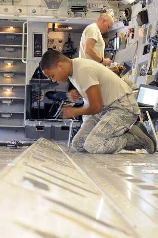 Airman 1st Class Quentel Riley replaces a variable restraint assembly on a Charleston C-17. The VRA is used to lock pallets of cargo into place during flight. Airman 1st Class Riley is attached to the 437th Aircraft Maintenance Squadron onboard Joint Base Charleston-Air Base. (U.S. Navy photo/Mass Communication Specialist 1st Class Jennifer Hudson)