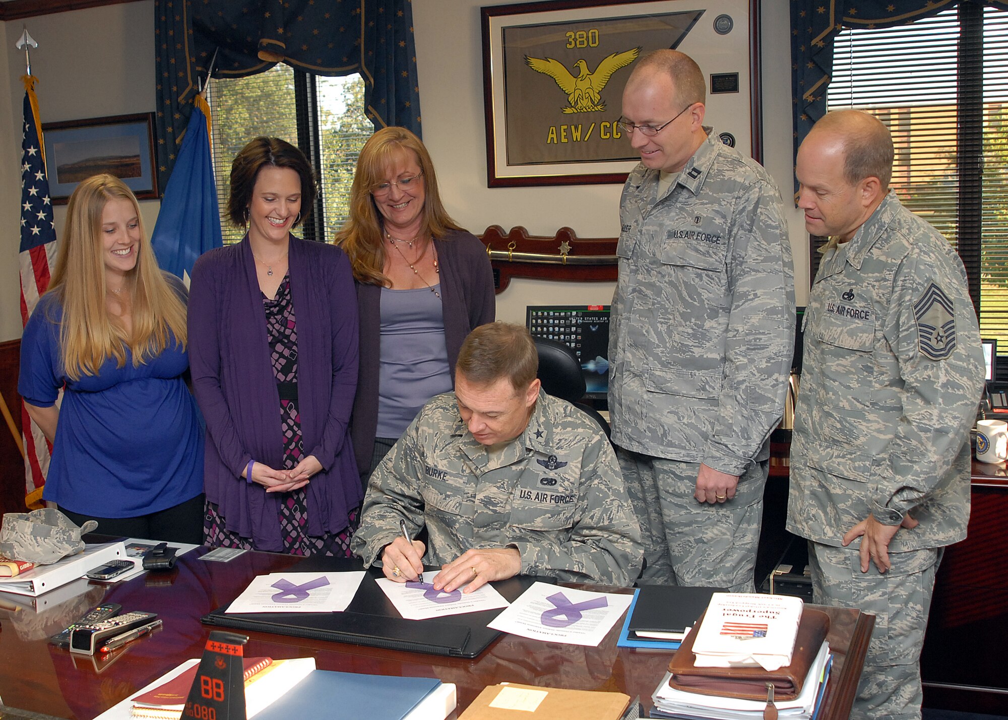Brig. Gen. Darryl Burke, 82nd Training Wing commander, signs the Domestic Violence Awareness Month proclamation, urging increased awareness of domestic violence issues at Sheppard Air Force Base, Texas, Oct. 1.  Pictured at the signing are 82nd Medical Group Family Advocacy Program Team members Kristen Freeman, the Treatment Manager, Tricia Kennedy, a domestic violence victim advocate, Sheri Ward, the FAP Outreach Manager, Capt. David Weller, the FAP Officer and Chief Master Sgt. David Hafner, 782nd Training Group superintendent. (U.S. Air Force photo/ Lou Anne Sledge)