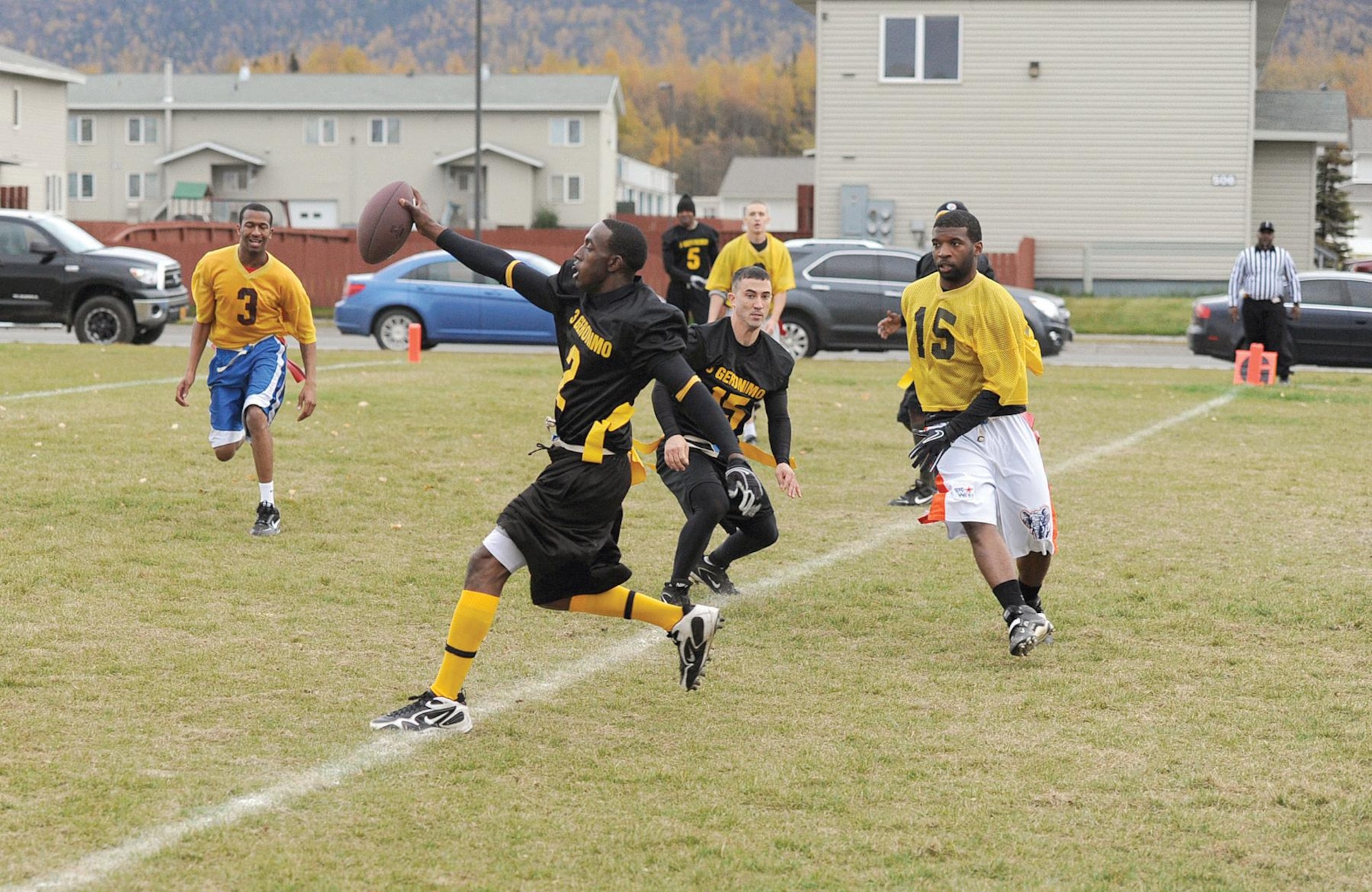 Patrick Spence, quarterback for the 3rd Battalion, 509th Infantry Regiment (Airborne) flag football team, carries the football across the goal line for the paratroopers’ third touchdown of the game. Two earlier touchdown passes to Tim Kincaid ensured an 18-7 victory. (U.S. Air Force photo/John Pennell)