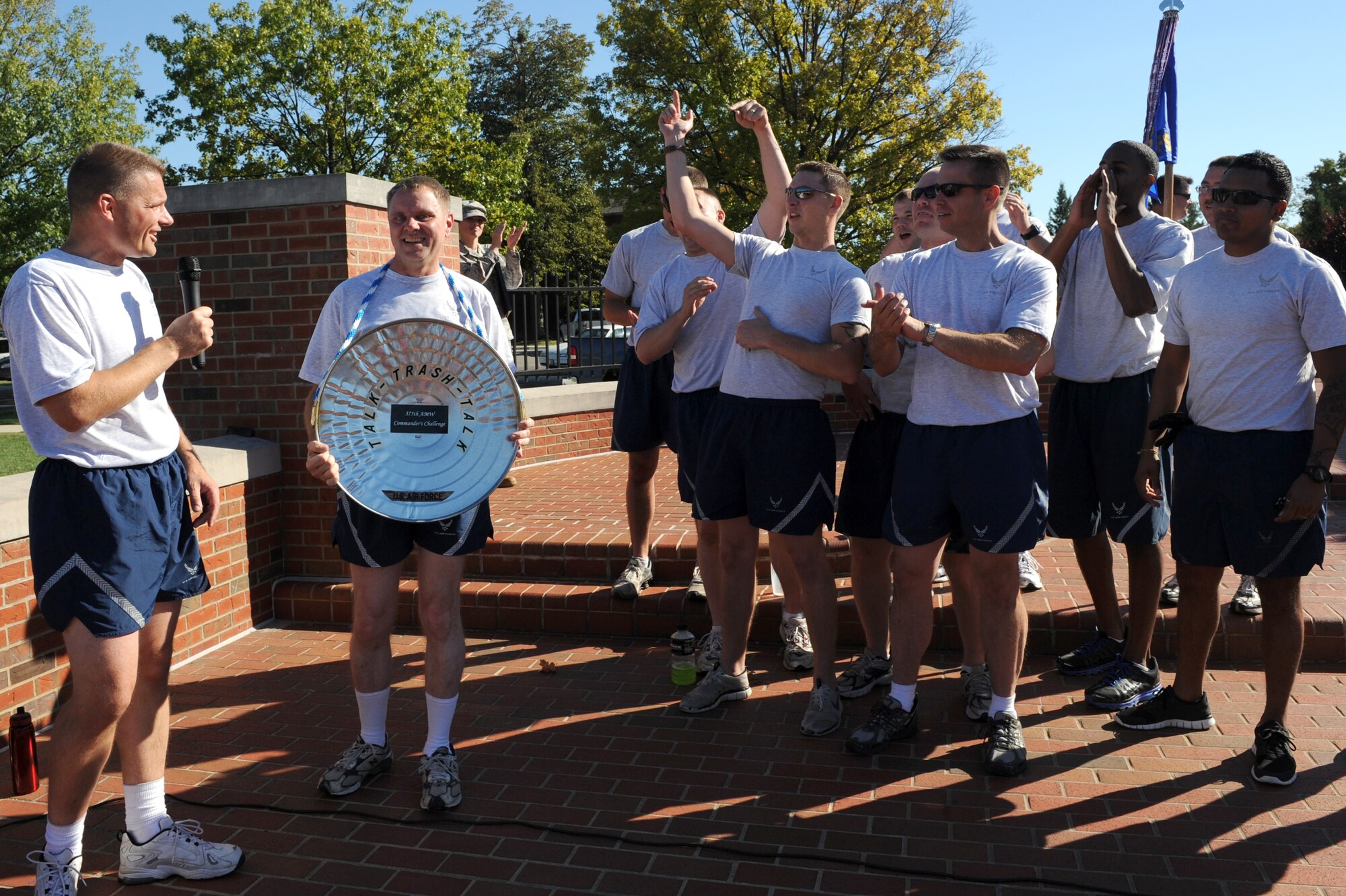 SCOTT AIR FORCE BASE, Ill. -- Col. Michael Hornitschek, 375th Air Mobility Wing commander, presents the 375th Security Forces Squadron with the Commanders Challenge trophy Oct. 1. They finished the relay with a time of 52 seconds. (U.S. Air Force photo/Staff Sgt. Teresa Jennings)