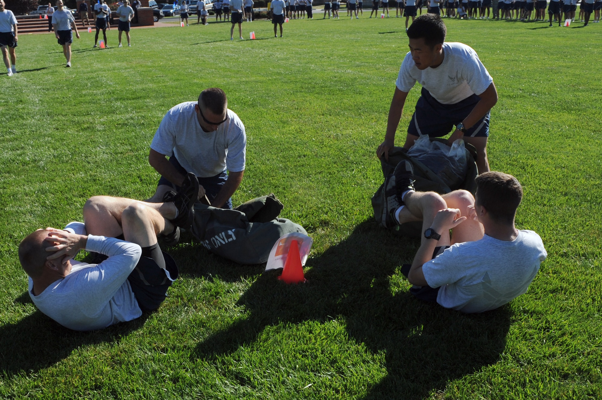 SCOTT AIR FORCE BASE, Ill. -- Lt. Col. Tracy Watkins, left, and 2nd Lt. Dan Riley, 375th Air Mobility Wing staff, complete the sit-up portion of the Commanders Challenge Oct. 1. Wing staff came in second place overall with the 375th Security Forces Squadron coming in first and the 375th Civil Engineer Squadron finishing third. (U.S. Air Force photo/Staff Sgt. Teresa Jennings)