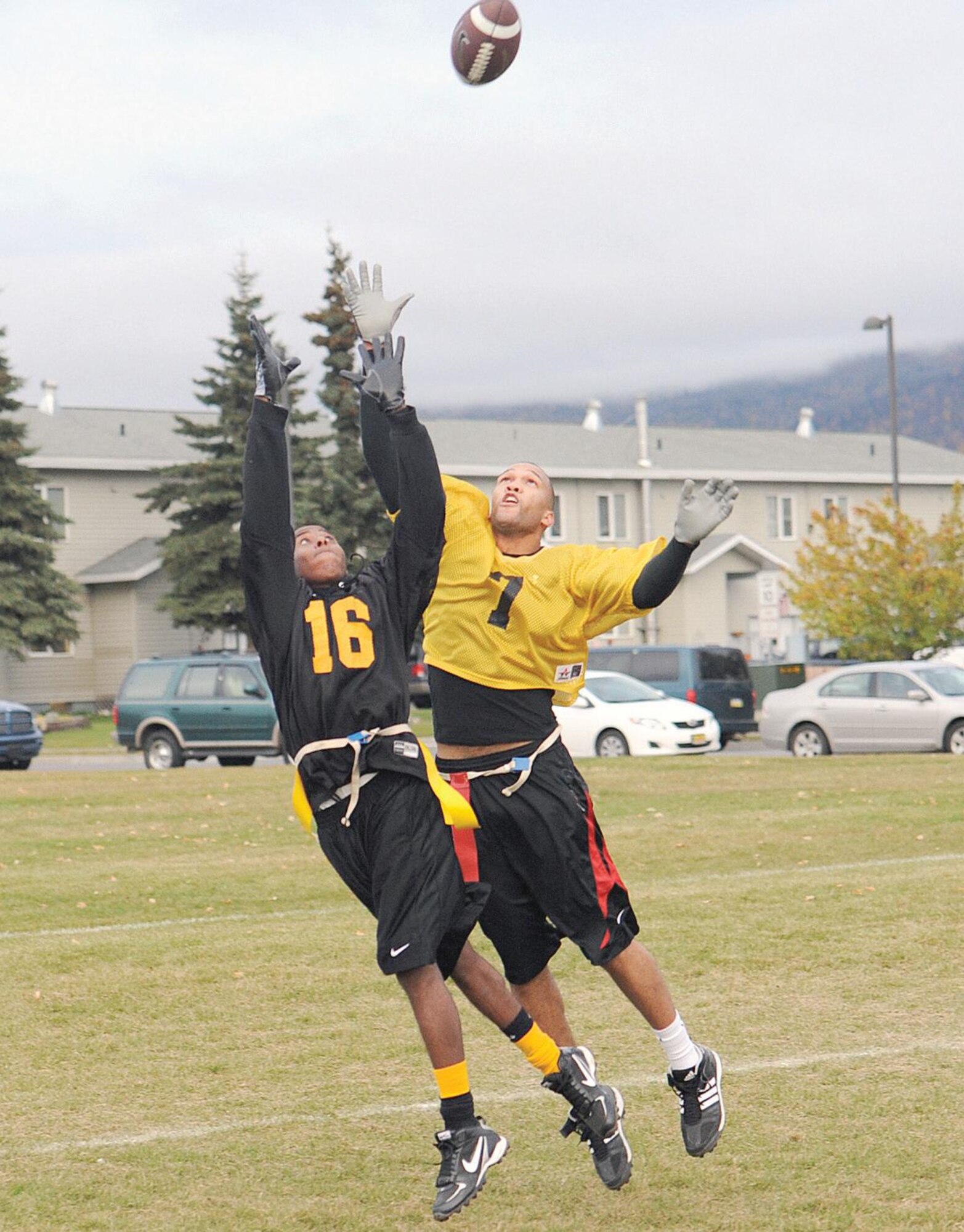 Hampton Miller, 3rd Equipment Maintenance Squadron, (yellow jersey) and Tim Kincaid, 3rd Battalion, 509th Infantry Regiment (Airborne), vie for a pass in the endzone. Miller managed to knock away the potential 3-509th touchdown pass. (U.S. Air Force photo/John Pennell)
