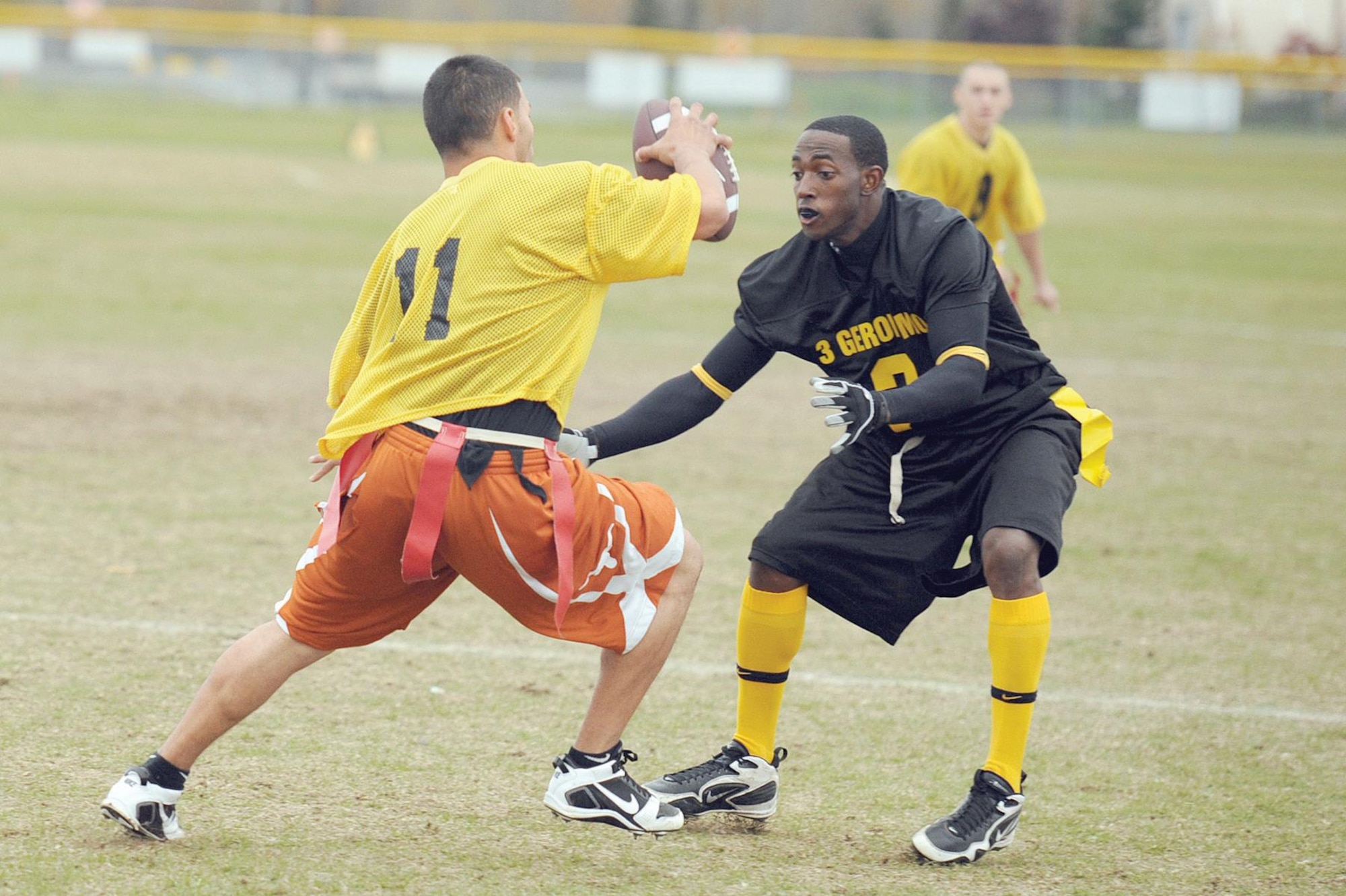 Richard Pantoja, 3rd Equipment Maintenance Squadron quarterback, tries to get past 3rd Battalion, 509th Infantry Regiment (Airborne) defender Patrick Spence. (U.S. Air Force photo/John Pennell)