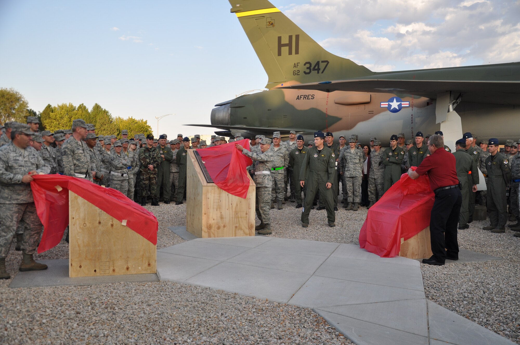 419th Fighter Wing Commander Col. Walter “Buck” Sams, Senior Master Sgt. Mike Iarossi and Chief Master Sgt. (retired) Howie Peterson unveil three memorial plaques at the newly dedicated Heritage Park Oct. 3. (U.S. Air Force photo/Staff Sgt. Alan Schultz)