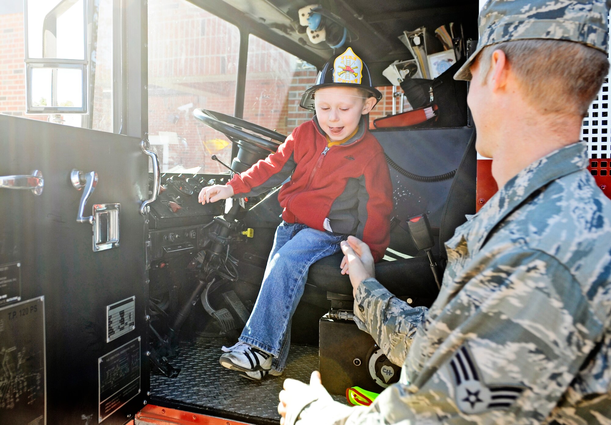 A child from the Child Development Center experiences the view from the front seat of a fire truck Oct. 5. In honor of Fire Safety Awareness Week, the Scott Air Force Base Fire Department provided fire safety awareness education and training throughout the week of Oct. 3-9. (U.S. Air Force photo/ Staff Sgt. Ryan Crane)