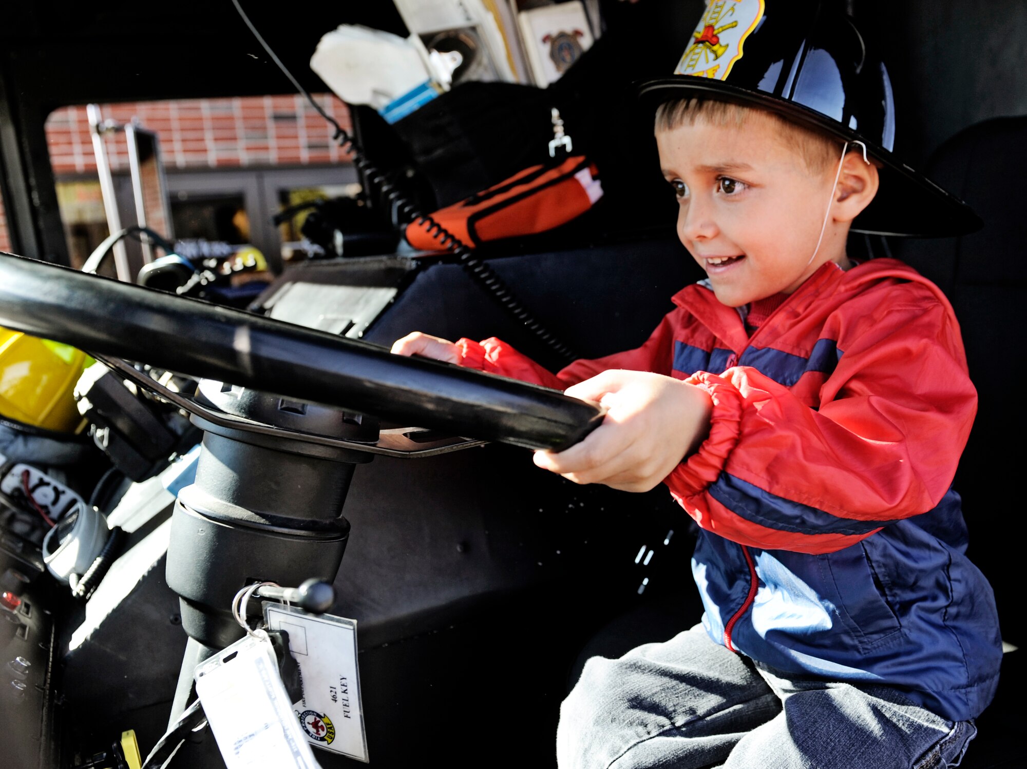A child from the Child Development Center experiences the view from the front seat of a fire truck Oct. 5. In honor of Fire Safety Awareness Week, the Scott Air Force Base Fire Department provided fire safety awareness education and training throughout the week of Oct. 3-9. (U.S. Air Force photo/ Staff Sgt. Ryan Crane)