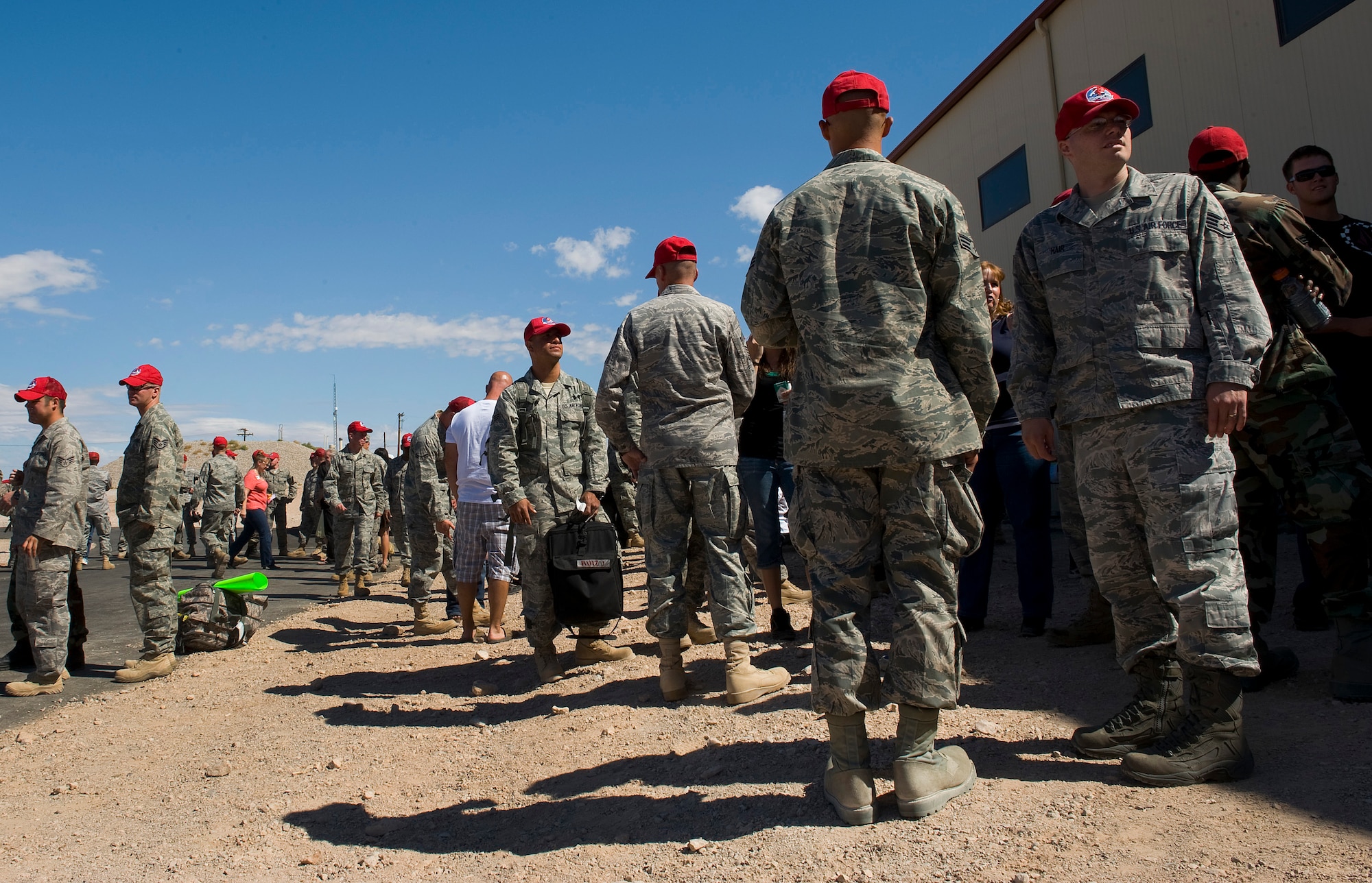 NELLIS AIR FORCE BASE, Nev.-- Airmen from the 820th RED HORSE Squadron welcome back deployed RED HORSE Airmen Oct. 5th. The Airmen were deployed to Afghanistan for six months for engineering support. (U.S. Air Force photo by Senior Airman Brett Clashman)