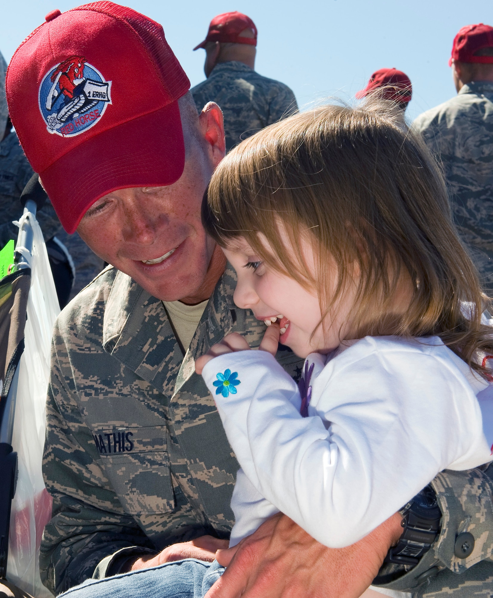 NELLIS AIR FORCE BASE, Nev.-- Tech. Sgt. Brandon Mathis, a pavement and equipment specialist from the 820th RED HORSE Squadron, holds his daughter, Audrie, after returning to Nellis Oct. 5th. Airmen of the 820th RHS were deployed to Afghanistan for six months for engineering support. (U.S. Air Force photo by Senior Airman Brett Clashman)