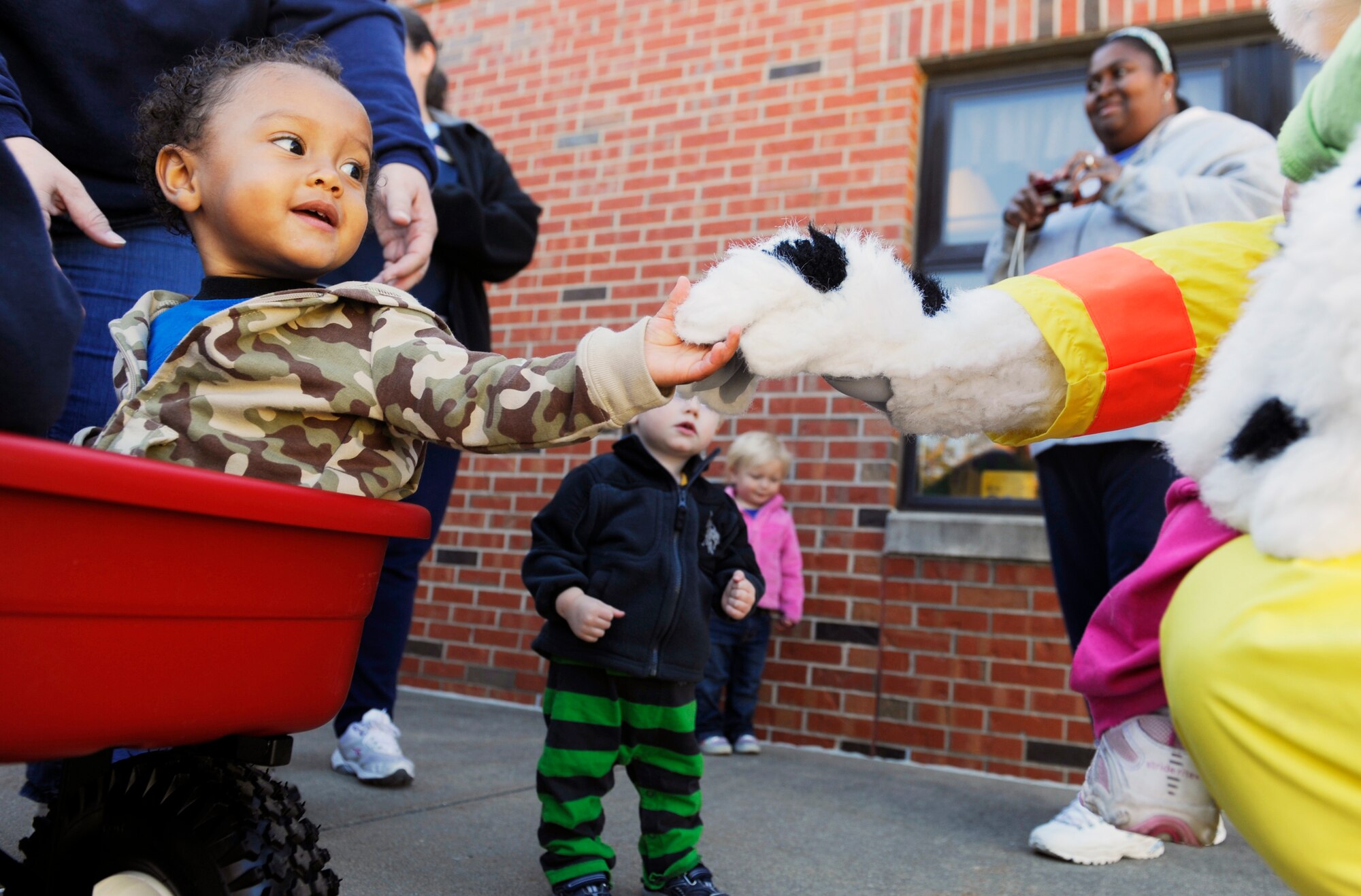 A child from the toddler age group at the Child Development Center meets Sparky the Fire Dog Oct. 5. In honor of Fire Safety Awareness Week, the Scott Air Force Base Fire Department will provide fire safety awareness education and training throughout the week of Oct. 3-9. (U.S. Air Force photo/ Staff Sgt. Ryan Crane)