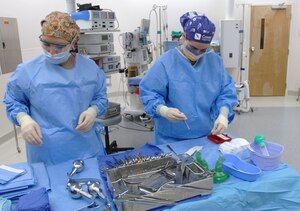 LANGLEY AIR FORCE BASE, Va. -- Senior Airman Stephanie Eddy (left) and Airman 1st Class Krystal Woolverton, 633d Surgical Operations Squadron surgical technologists, prepare the surgical field prior to a surgery at the Langley hospital Oct. 5. The 633d Medical Group employs 22 surgical technologists, boasting a combined experience of more than 50 years. (U.S. Air Force photo/Airman 1st Class Jason J. Brown) (RELEASED)