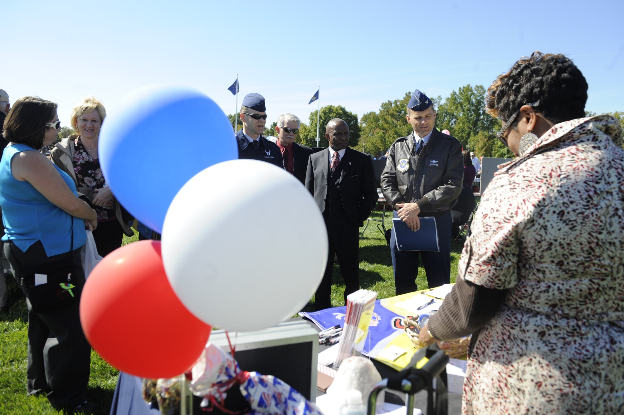 Col. Michael Hornitschek, 375th Air Mobility Wing commander, speaks with the Autism Awareness Chapter at the Combined Federal Campaign fundraiser kick off at the parade field Oct. 4. The 2010 Combined Federal Campaign kicked off with an outdoor lunch, informative briefings about what the CFC is all about, and a chance to meet base CFC representatives and donate. (U.S. Air Force photo/ Staff Sgt. Ryan Crane)