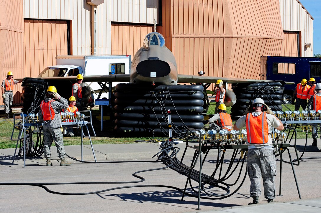 ELLSWORTH AFB, S.D. - Airmen of the 28th Maintenance Squadron repair and reclamation section use crash recovery equipment to lift an F-100A Super Sabre, Sept 27.  Because active aircraft can’t be lifted during training exercises, the 28th MXS coordinated with the South Dakota Air and Space Museum to lift the display F-100A. The 28th Maintenance Squadron repair and reclamation section is responsible for crash recovery; they manage clean-up efforts in the event of an aircraft incident on the airfield. (U.S. Air Force photo/Staff Sgt. Marc I. Lane)