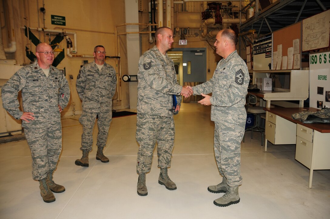 Chief Master Sgt. Dwight Badgett, Air Force Reserve Command command chief, presents Tech. Sgt. Jeremy Lis, 914th Maintenance Squadron aircraft mechanic and inspector, with his brand new E-6 stripes. Chief Badgett visited Niagara Air Reserve Station during the October Unit Training Assembly as part of his commitment to visit 36 installations over 36 months. During his visit, the chief visited Airmen from nearly every unit, speaking about important elements of being an Air Force reservist and asking for anyone to present questions, concerns or advice to take back to command. (Air Force photo/Senior Airman Chelsea Gitzen)