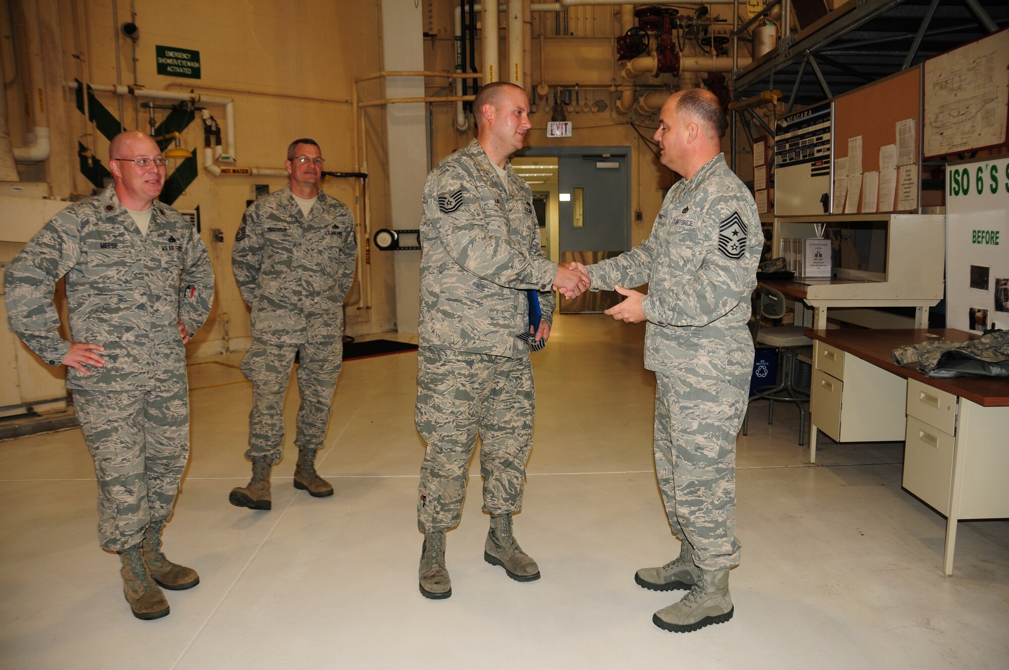 Chief Master Sgt. Dwight Badgett, Air Force Reserve Command command chief, presents Tech. Sgt. Jeremy Lis, 914th Maintenance Squadron aircraft mechanic and inspector, with his brand new E-6 stripes. Chief Badgett visited Niagara Air Reserve Station during the October Unit Training Assembly as part of his commitment to visit 36 installations over 36 months. During his visit, the chief visited Airmen from nearly every unit, speaking about important elements of being an Air Force reservist and asking for anyone to present questions, concerns or advice to take back to command. (Air Force photo/Senior Airman Chelsea Gitzen)