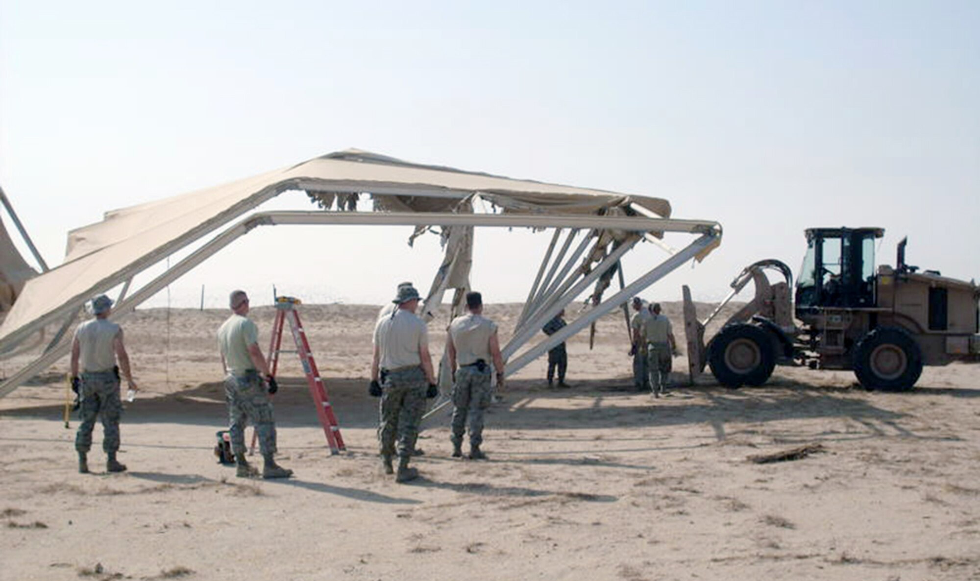 Airmen from the 386th Expeditionary Civil Engineer Squadron demolish sunshades Sept. 2, 2010, in Southwest Asia. More than 9,470 pounds of scrap metal, with a value of more than $4,700, were collected during the tear-down. (Courtesy photo)