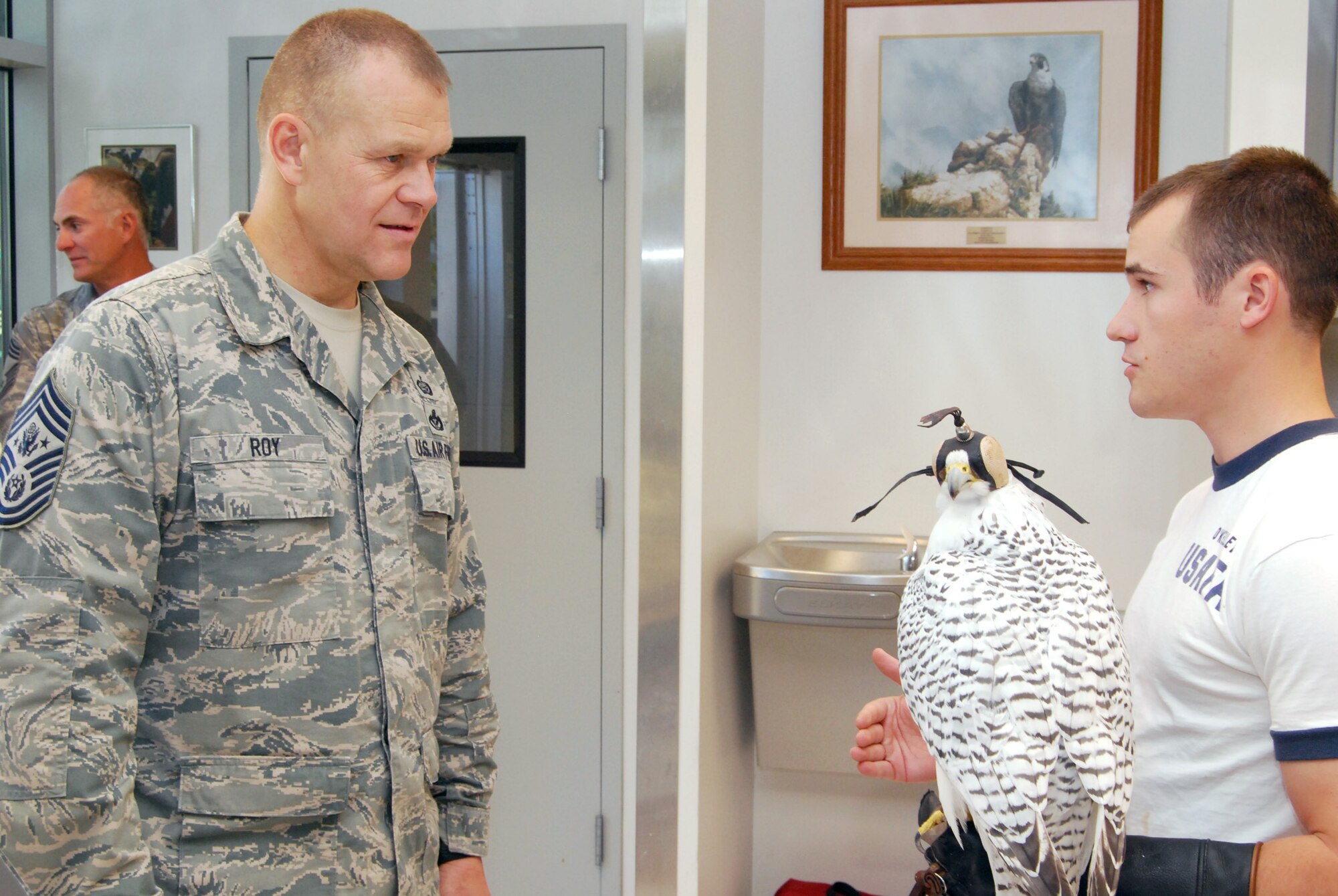 Cadet 2nd Class Michael O'Kelley (right) talks to Chief Master Sgt. of the Air Force James A. Roy about the U.S. Air Force Academy's falconry program during a visit to the Academy. (U.S. Air Force photo/Staff Sgt. Don Branum)
