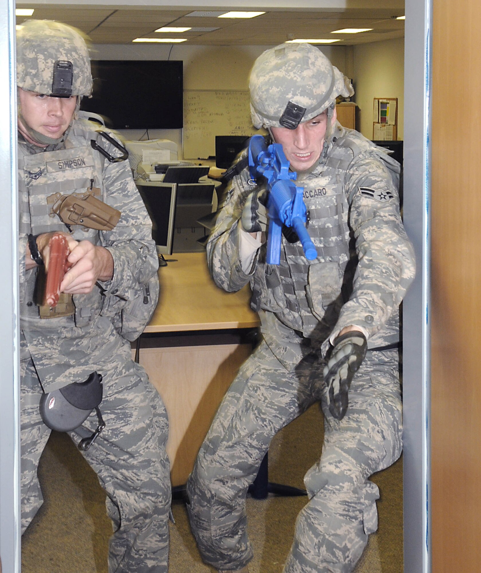 Staff Sgt. David Simpson (left) and Airman 1st Class Anthony Vaccaro rush into a room to clear it during active shooter training Oct. 4, 2010, at Spangdahlem Air Base, Germany. Sergeant Simpson is a 52nd Security Forces Squadron K-9 handler. Airman Vaccaro is a 52nd SFS patrolman. (U.S. Air Force photo/Staff Sgt. Logan Tuttle)