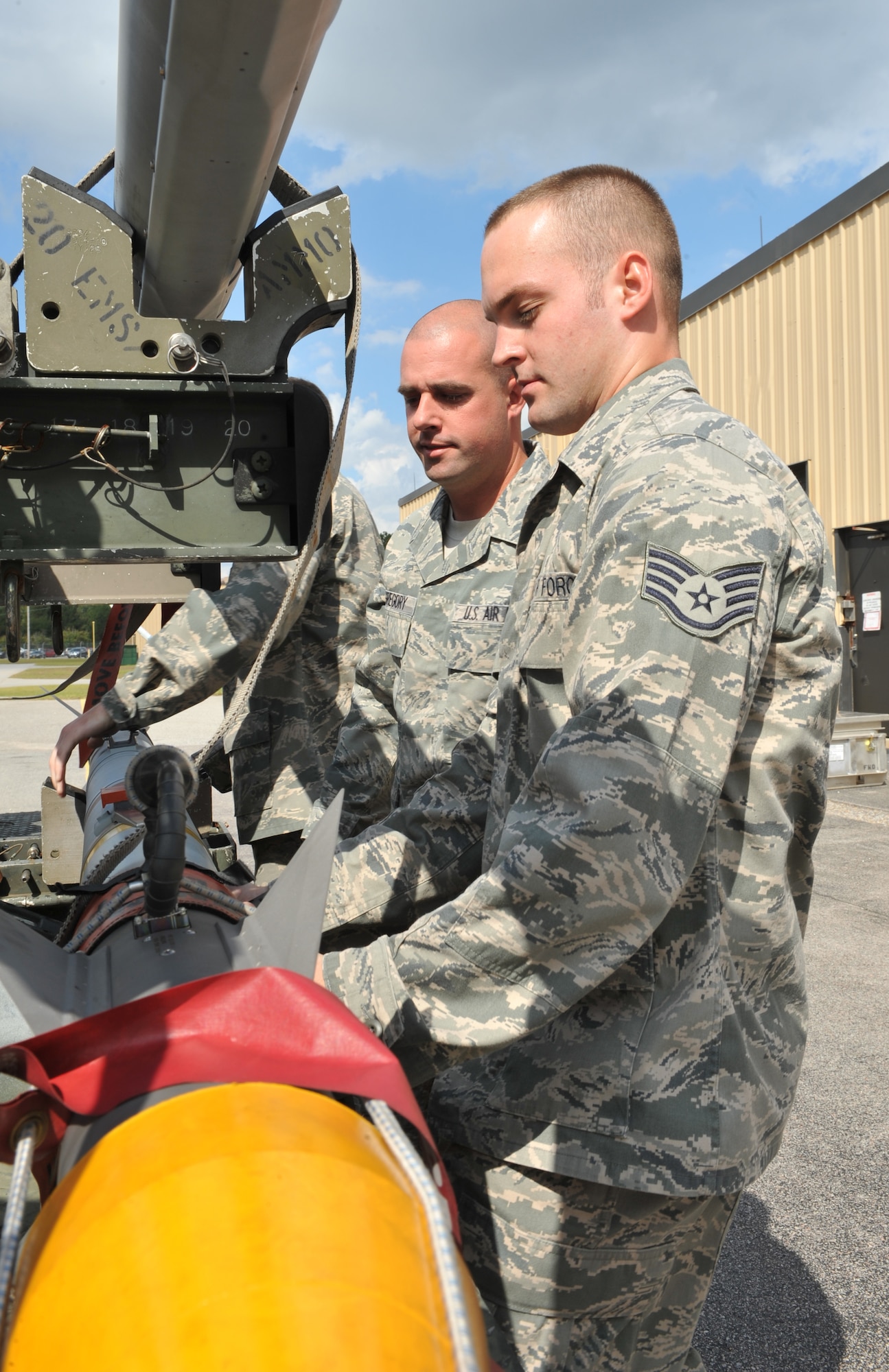 101004-F-4406D-004 SHAW AIR FORCE BASE, S.C.--    Staff Sgt. Brian Parker and Staff Sgt. Nathan DeGregory, 20th Equipment Maintenance Squadron precision guided munitions crew chiefs, secure an Air Intercept Missile-9X onto a trailer Oct. 4, 2010. The ammo shop plays a key role in ensuring missiles are built, pre-inspected and accounted for before they are loaded on trailers and delivered to the flightline. (U.S. Air Force photo/ Airman 1st Class Tabatha L. Duarte(Released)