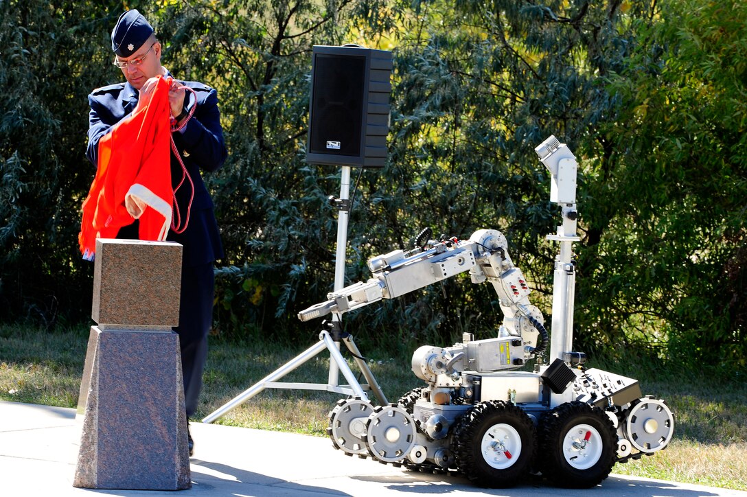 ELLSWORTH AFB, S.D. - Lt. Col. Matthew Joganich, 28th Civil Engineer Squadron commander, unveils the memorial block dedicated to Staff Sgt. Bryan Berky at Heritage Park, Oct. 1.  Sergeant Berky deployed multiple times in support of Operations Iraqi and Enduring Freedom as an explosive ordnance disposal technician. (U.S. Air Force photo/Staff Sgt. Marc I. Lane)