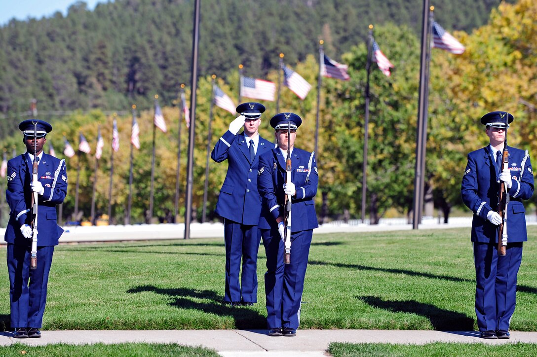 ELLSWORTH AFB, S.D. - Members of the Ellsworth Honor Guard perform a 21-gun salute at the Black Hills National Cemetery in honor of America’s prisoners of war and missing in action, Oct. 1.  Observances of National POW/MIA Remembrance Day are held across the country on military installations, ships at sea, state capitols, schools and veterans' facilities. (U.S. Air Force photo/Staff Sgt. Marc I. Lane)