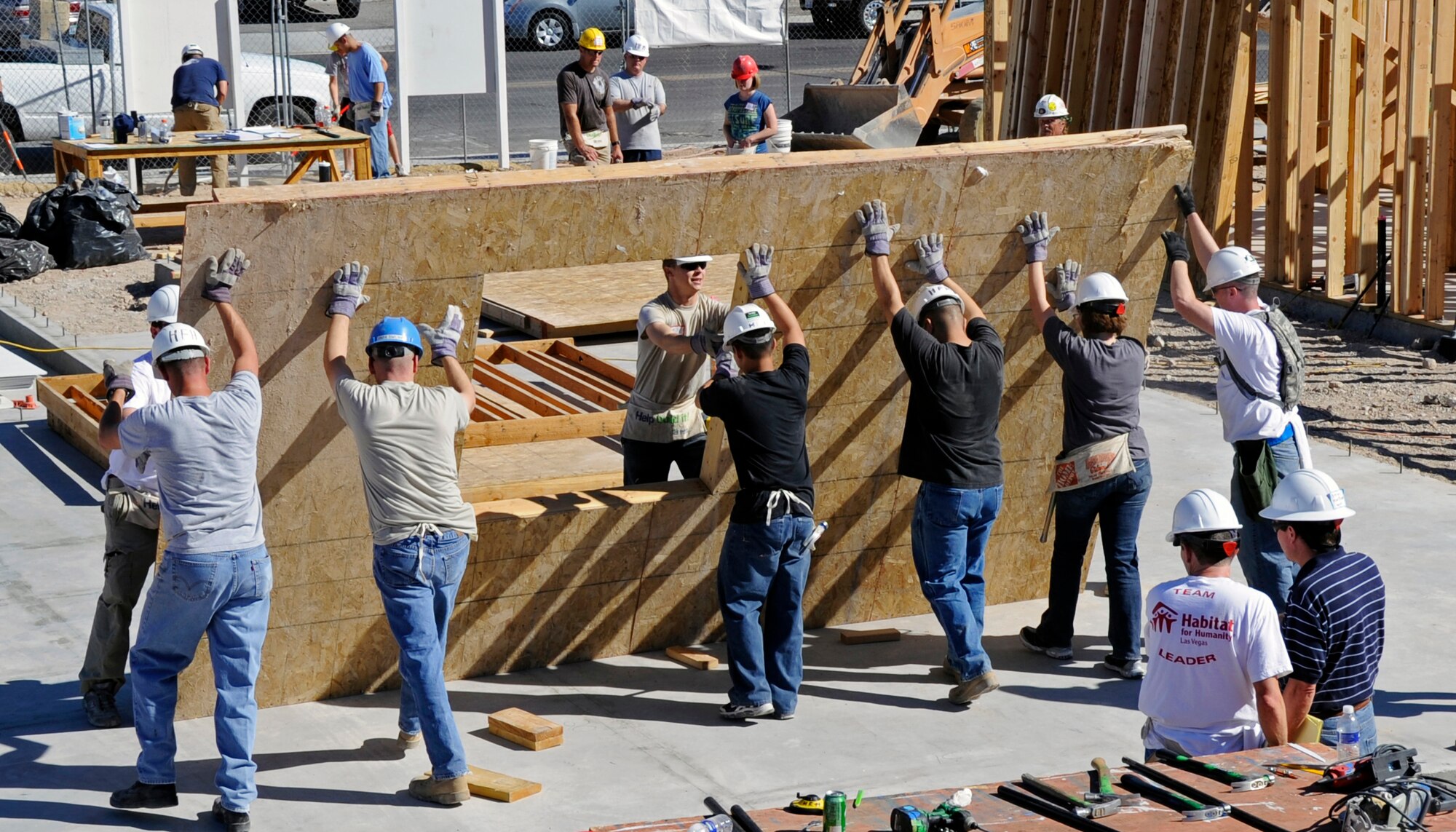 LAS VEGAS -- Personnel from Creech Air Force Base position a wall section during a Creech Top Three sponsored Habitat for Humanity event in Las Vegas Sept 18. (U.S. Air Force Photo)