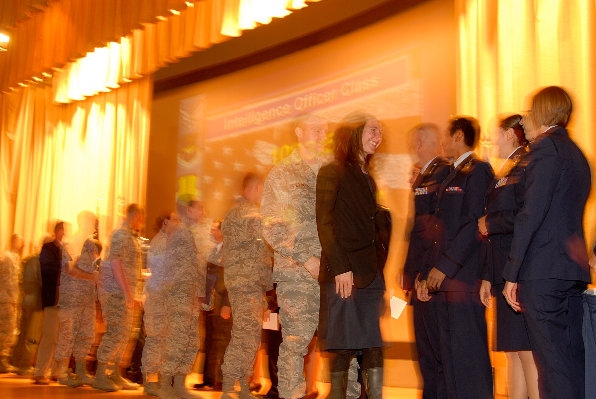 GOODFELLOW AIR FORCE BASE, Texas – Well wishers greet Intelligence, Surveillance and Reconnaissance students of Intelligence Officers Course at the theater here Sept. 29. Lt. Gen. David Deptula, Air Force Deputy Chief of Staff for ISR, traveled to Goodfellow to award the graduates their badges in person. (U.S. Air Force photo/ Senior Airman Tong Duong)