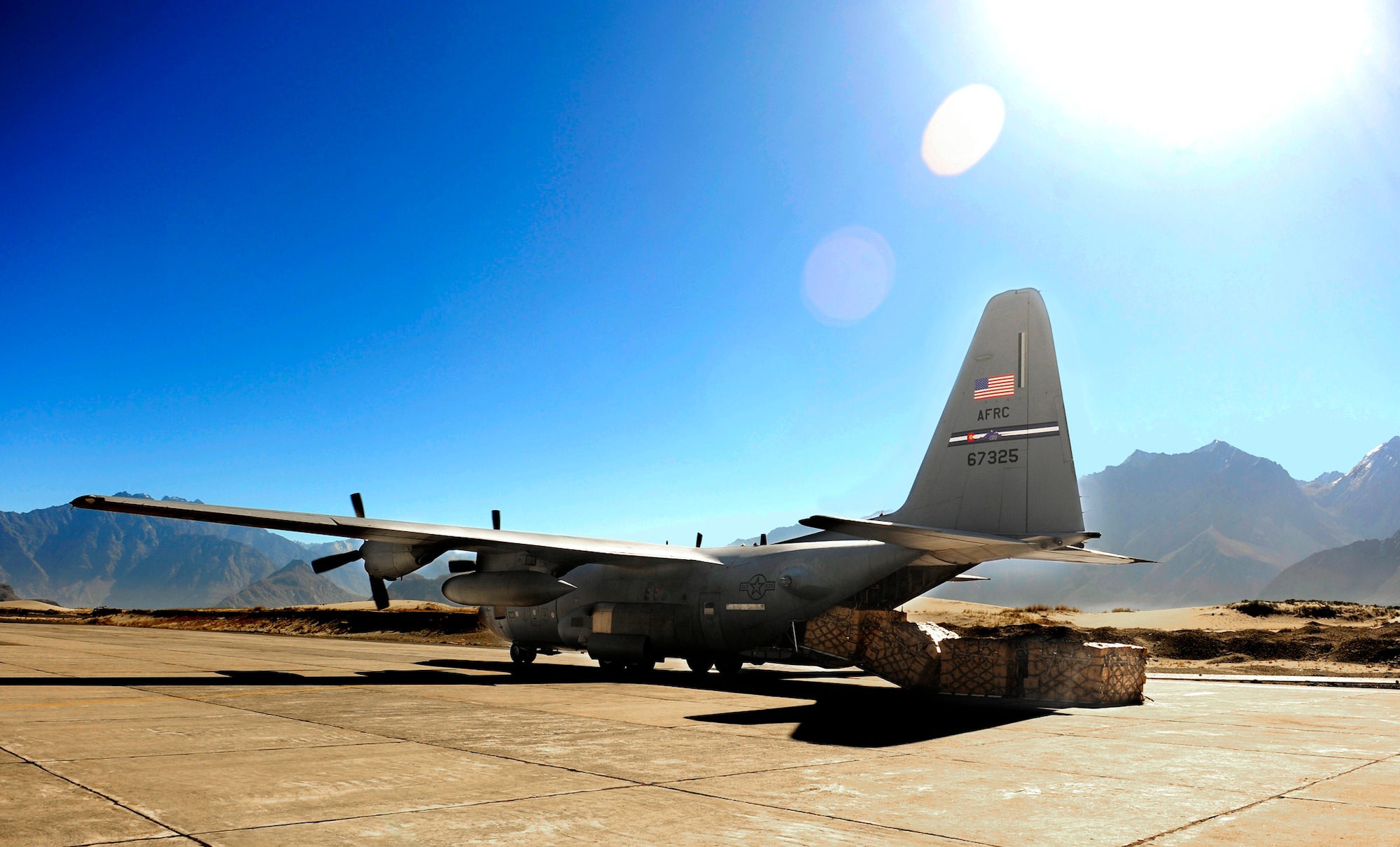 A U.S. Air Force C-130 Hercules aircrew performs a rolling offload of relief supplies at Skardu Airfield, Pakistan, recently. U.S. military aircrews, working in close coordination with the Pakistan military, have transported more than 6.6 million kilograms of relief supplies and evacuated 21,000 people in the flood-affected regions of Pakistan during August and September. (U.S. Air Force photo/Staff Sgt. Andy Kin)