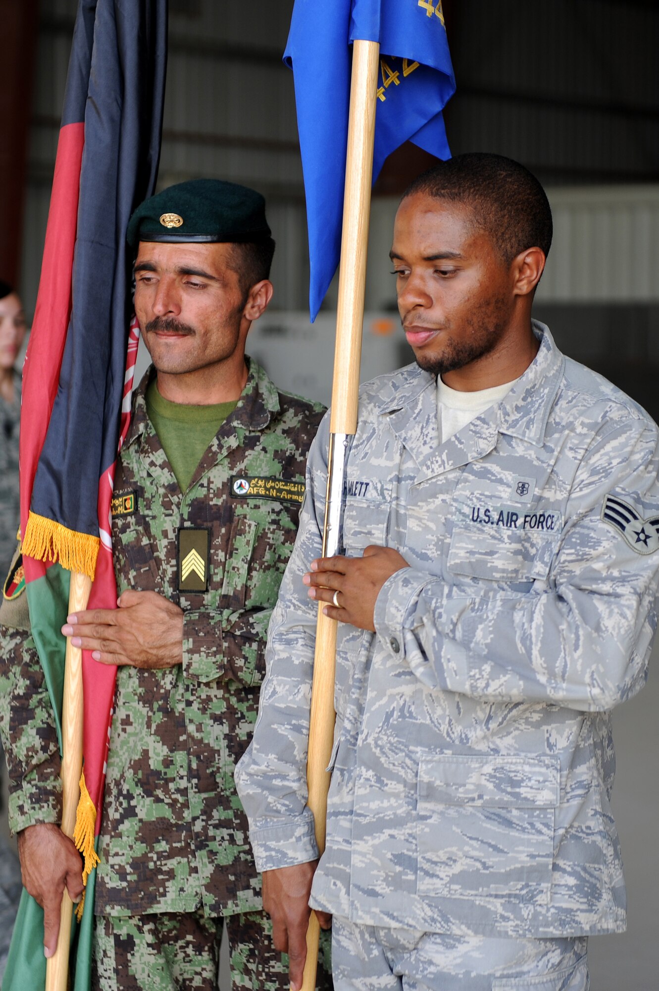 Senior Airman Nikkos Hamlett and an Afghan airman practice posting colors Oct. 3, 2010, at Kandahar Airfield, Afghanistan. Airman Hamlett, from Appomattox Va., is a pharmacy journeyman assigned to the 451st Expeditionary Aeromedical Evacuation Squadron.  (U.S. Air Force photo by Tech. Sgt. Chad Chisholm/Released)