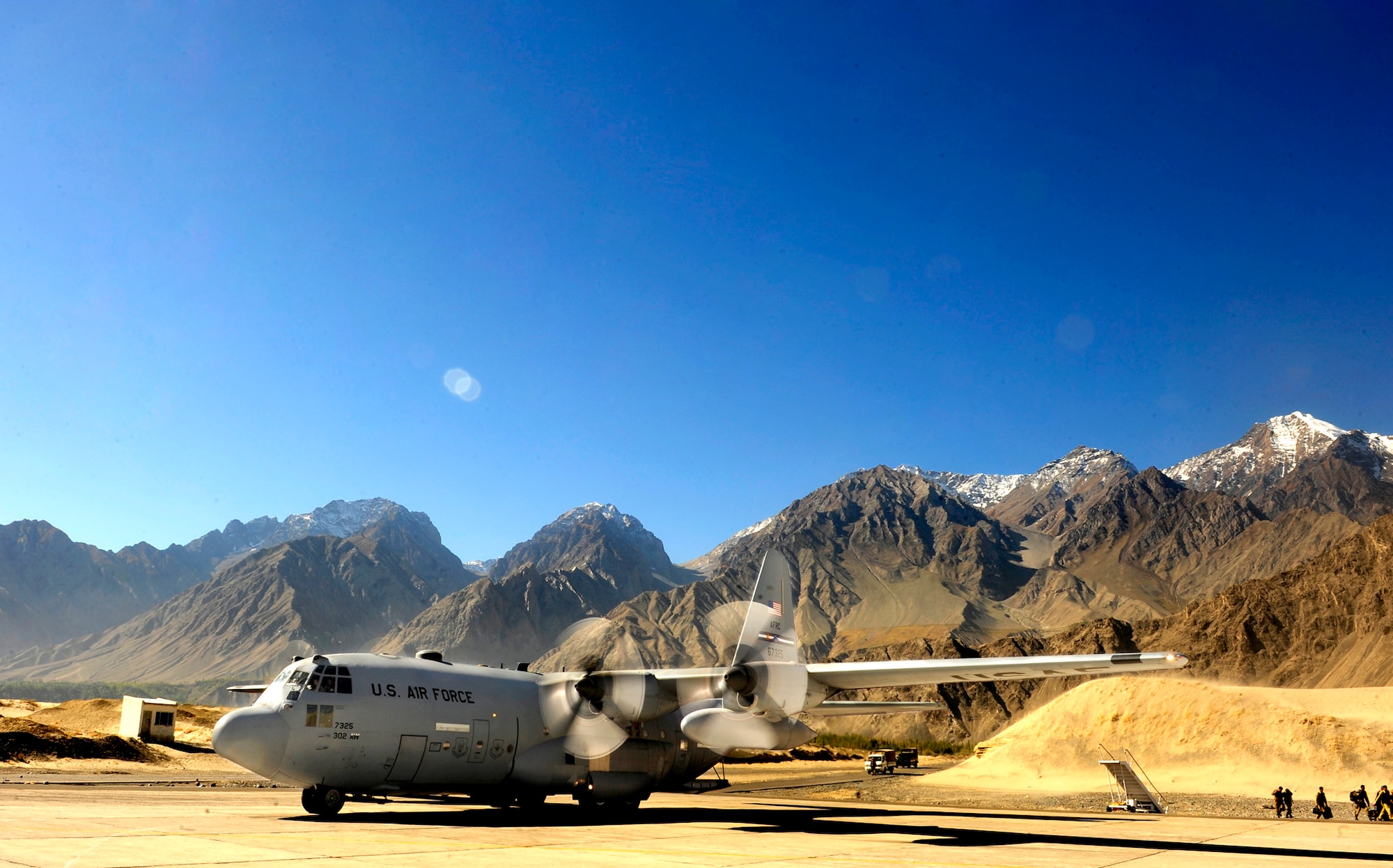 A U.S. Air Force C-130 Hercules is positioned to unload humanitarian aid supplies Oct. 3 at Skardu airfield, Pakistan. U.S. military aircrews, working in close coordination with the Pakistan military, have transported more than 6.6 million kilograms of relief supplies and evacuated 21,000 people in the flood-affected regions of Pakistan during August and September. (U.S. Air Force photo/Staff Sgt. Andy Kin)