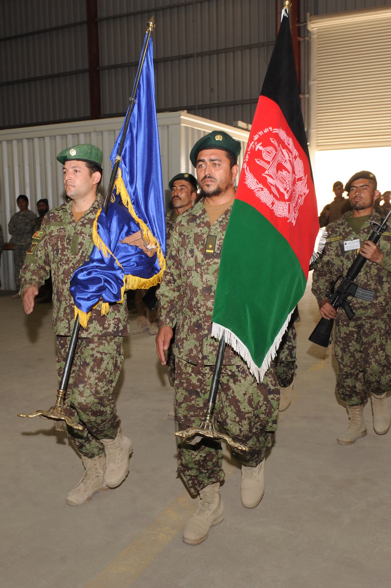 Airmen from the Kandahar Air Wing post the flag of the Islamic Republic of Afghanistan during a ceremony marking the first anniversary of the unit’s activation, Oct. 5, 2010, at Kandahar Airfield, Afghanistan.  The 451st Air Expeditionary Wing Honor Guard worked with the Afghans to help them stand up their own Honor Guard. (U.S. Air Force photo by Tech. Sgt. Chad Chisholm/Released)