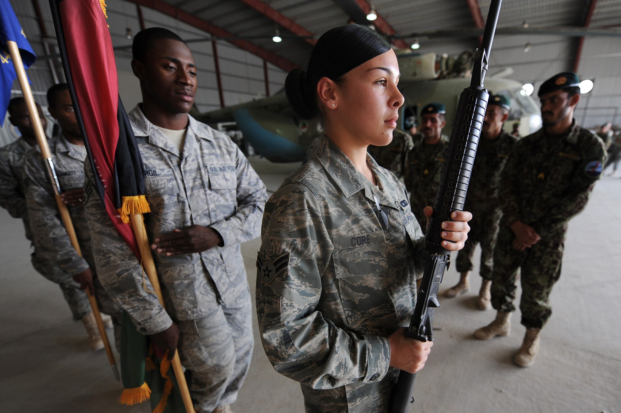 Members of the 451st Air Expeditionary Wing Honor Guard demonstrate how to post colors Oct. 3, 2010, at Kandahar Airfield, Afghanistan.  The 451st AEW Honor Guard worked with the Afghans to help them prepare their own Honor Guard for a ceremony marking the one year anniversary of the Kandahar Air Wing.  (U.S. Air Force photo by Tech. Sgt. Chad Chisholm/Released)