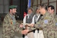 Maj. Gen. Abdul Raziq Sherzai, commander of the Kandahar Air Wing, presents an Afghan Airman with a certificate during a ceremony marking the first anniversary of the activation of the KAW, Oct. 5, 2010, at Kandahar Airfield, Afghanistan. The KAW currently maintains and operates five Mi-17 helicopters and also supports transient fixed wing aircraft. (U.S. Air Force photo by Tech. Sgt. Chad Chisholm/Released)