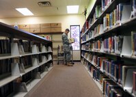 MINOT AIR FORCE BASE, N.D. -- Airman 1st Class John C. Auer, 17th Munitions Squadron nuclear weapons maintainer, is one of several volunteers who helped arrange books at the base library Oct. 1. The library underwent renovations and remodeling designed to improve the quality of service provided to Air Force Global Strike Command Airmen stationed here. (U.S. Air Force photo by Airman 1st Class Aaron-Forrest Wainwright)