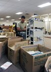 MINOT AIR FORCE BASE, N.D. -- Airman 1st Class Christopher D. Clark, 17th Munitions Squadron nuclear weapons maintainer, is one of several volunteers who helped arrange books at the base library Oct. 1. The library underwent renovations and remodeling designed to improve the quality of service provided to Air Force Global Strike Command Airmen stationed here. (U.S. Air Force photo by Airman 1st Class Aaron-Forrest Wainwright)
