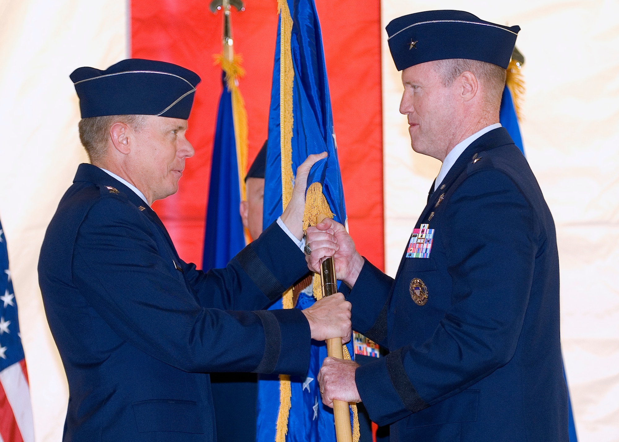 General Donald J. Hoffman, commander of Air Force Materiel Command, hands the Air Force Flight Test Center flag to Brig. Gen. Robert C. Nolan II, signifying the transfer of command Oct. 5.  (Air Force photo by Rob Densmore)
