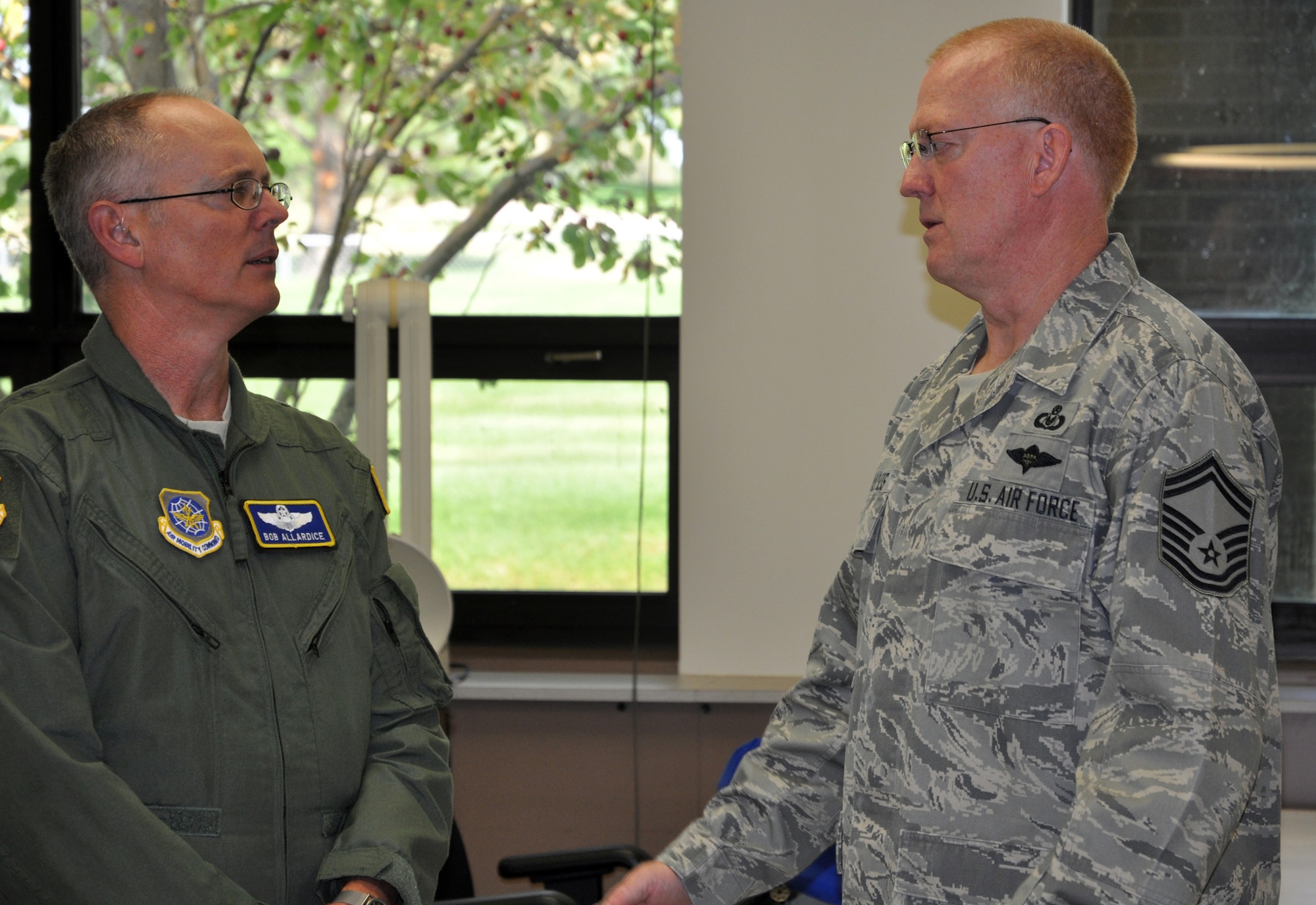 Lt. Gen. Robert Allardice, 18th Air Force commander (left) listens to Senior Master Sgt. William Schultheis during his Oct. 3 tour of the 302nd Airlift Wing at Peterson Air Force Base, Colo. General Allardice spent time with members of the 302nd AW and their Active Duty counterparts in the 52nd Airlift Squadron to gauge the effects of Total Force Integration during an Air Force Reserve duty weekend. Sergeant Schultheis is the 302nd Operations Support Squadron aircrew flight equipment superintendent. (U.S. Air Force photo/Tech. Sgt. Daniel Butterfield)