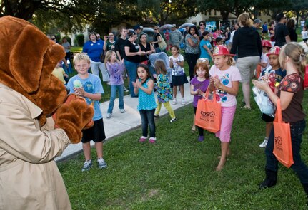 McGruff ,the crime fighting dog, from the 902 Security Forces Squadron, entertains the children at the Randolph National Night Out.  Randolph Security Forces and Fire Department were on hand to educate people on how they can help fight crime in residential neighborhoods.  (U.S. Air Force Photo By Don Lindsey)