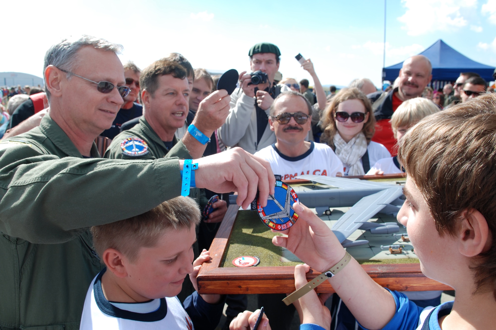 Lt. Col. Joseph “Doc” Jones, 93rd Bomb Squadron commander, and Colonel Keith Schultz, 917th Operations Group commander, hand patches to members of the Junior Modelers Club of Sazava during the 10th Annual NATO Days in Ostrava air show, Ostrava, Czech Republic, Sept. 18, 2010. Colonels Schultz and Jones were part of history as members of the B-52H Stratofortress aircrew that landed at the Leoš Janácek Airport in support of the air show, Sept. 15, 2010. The air show is the largest air, army and security show in Central Europe. This marked the first-time ever a B-52 bomber has visited the Czech Republic. The 917th OG and 93rd BS are assigned to the 917th Wing at Barksdale Air Force Base, La. (U.S. Air Force photo/Master Sgt. Greg Steele) 