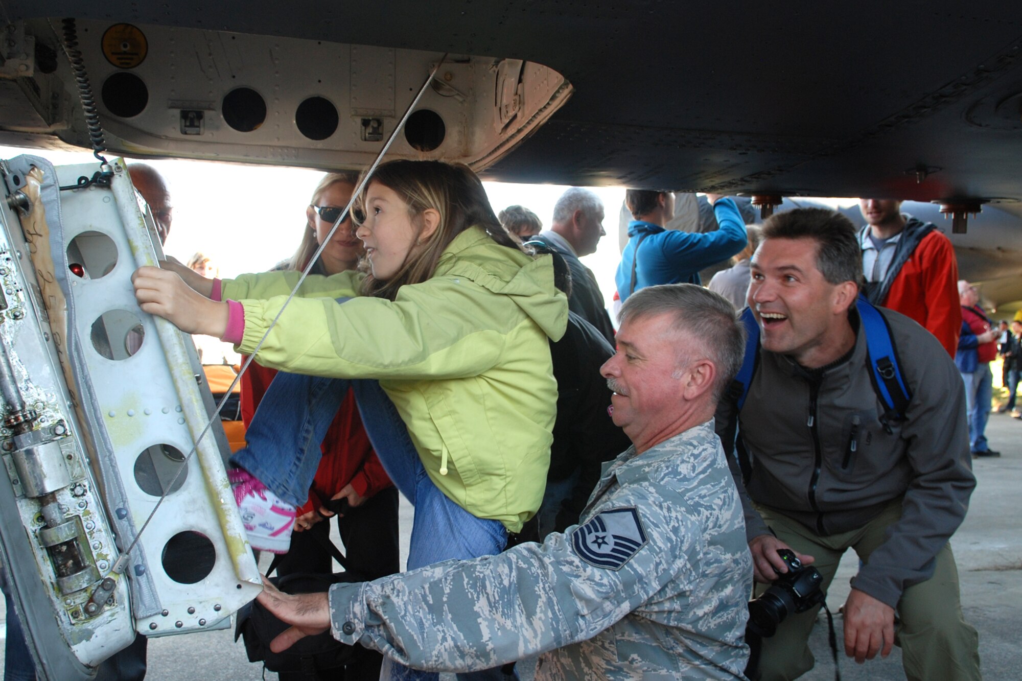Master Sgt. Wesley Phillips, flight chief, 917th Aircraft Maintenance Squadron helps a girl climb up the hatch of a B-52H Stratofortress during the NATO Days in Ostrava air show, Sept. 18, 2010. The 917th Wing deployed personnel and a B-52H Stratofortress to Ostrava, Czech Republic on Sept. 15, 2010 in support of the 10th Annual NATO Days in Ostrava air show, which is the largest air, army and security show in Central Europe. This marked the first-time ever that a B-52 bomber has visited the Czech Republic. (U.S. Air Force photo/Master Sgt. Greg Steele) 