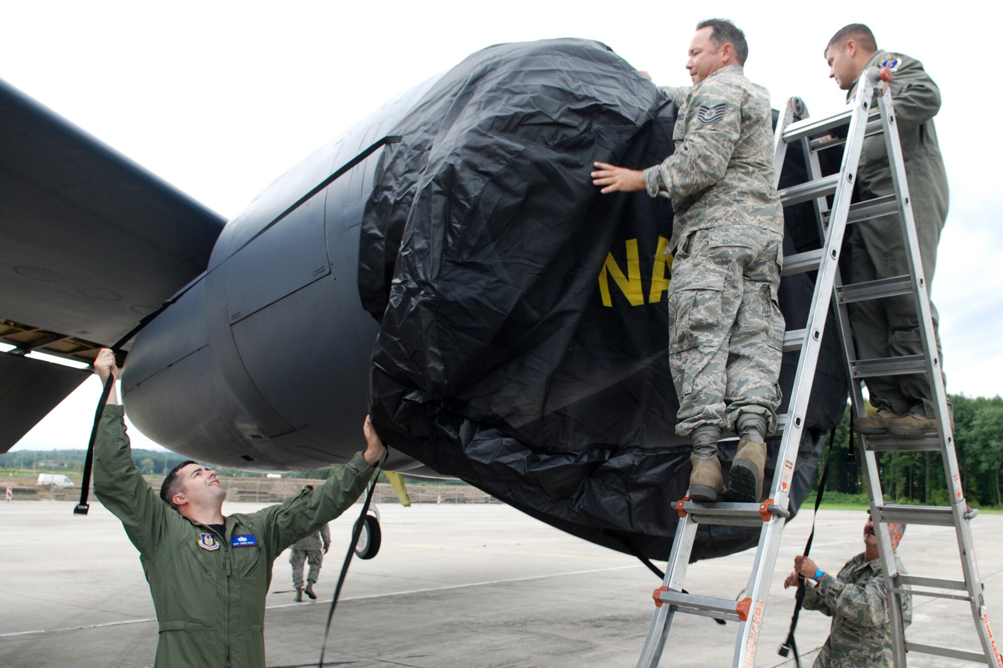 Staff Sgts. James Beal and Dennis Varnado, along with Technical Sgts. David Johnson and Landon Holloway, install engine covers on a 917th Wing B-52H Stratofortress after its arrival at the Leoš Janácek Airport in Ostrava, Czech Republic, Sept. 15, 2010. This marks the first-time a B-52 bomber has visited the Czech Republic. It was flown there in support of the 10th Annual NATO Days in Ostrava air show, which is the largest air, army and security show in Central Europe. The engine covers show the North Atlantic Treaty Organization (NATO) acronym. The 917th Wing is located at Barksdale Air Force Base, La. (U.S. Air Force photo/Master Sgt. Greg Steele) 
