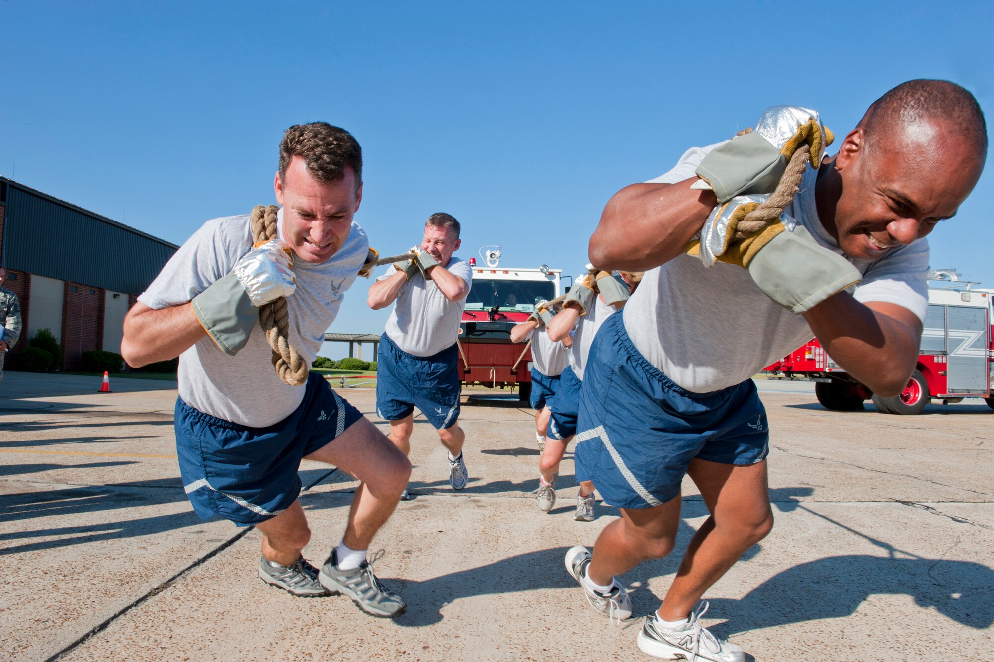 MOODY AIR FORCE BASE, Ga. -- Col. Chad Franks (left), 347th Rescue Group commander, and Col. Neal Robinson, 23rd Maintenance Group commander, lead their team in a P-19 firetruck pull during the annual Fire Prevention Week Fire Muster Oct. 4 at the 23rd Civil Engineer Squadron fire station. The commanders' team completed the fire muster with a time of 7:38, edging out the 23rd Logistics Readiness Squadron fuels management flight and their time of 8:18. (U.S. Air Force photo/Senior Airman Jamal D. Sutter)