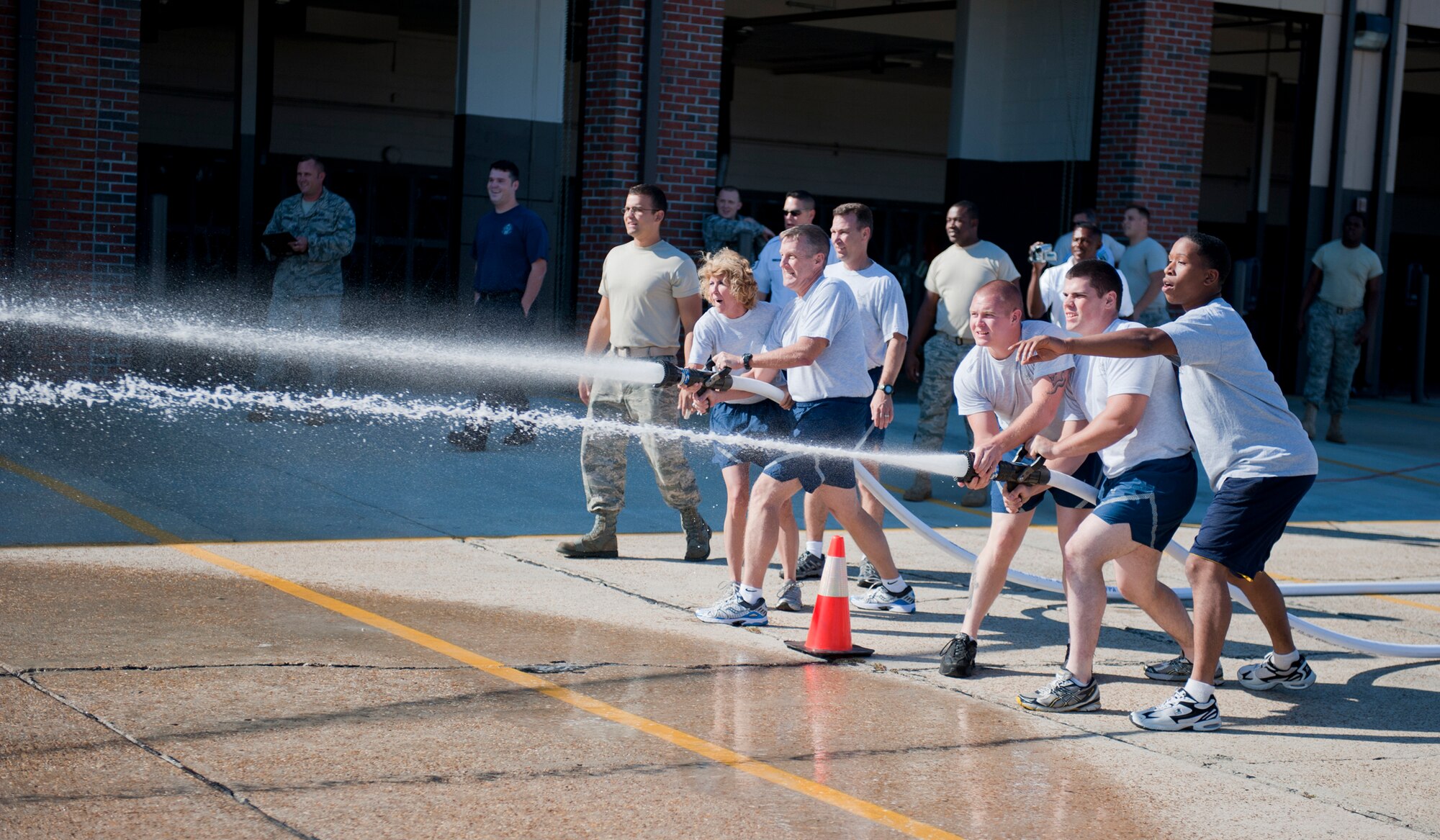 MOODY AIR FORCE BASE, Ga. -- Members of the 23rd Logistics Readiness Squadron fuels management flight compete against base leadership in a water stream drill Oct. 4 at the 23rd Civil Engineer Squadron fire station. The teams also competed in a rescue-dummy drag, bunker drill and P-19 firetruck pull. (U.S. Air Force photo/Senior Airman Jamal D. Sutter)