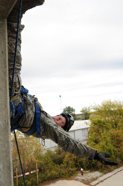 U.S. Air Force Master Sgt. Timothy Schitker a firefighter with the 180th Fighter Wing rappels down the side of a training facility at the Toledo Fire and Rescue Department Training Academy, October 5, 2010.  Firefighters from the 180th Fighter Wing are participating in six days of training designed to prepare them for various rescue situations. (U.S. Air Force photo by Senior Airman Amber Williams/Released)