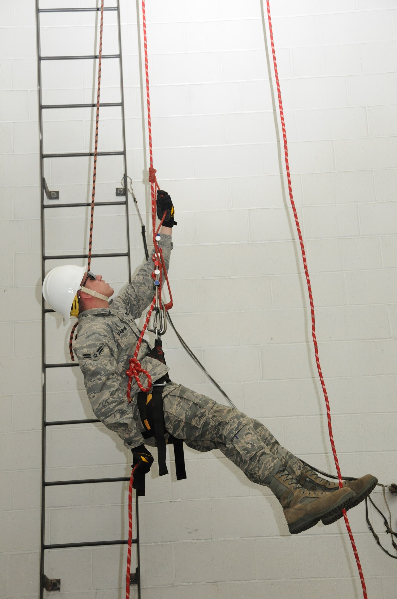 U.S. Air Force firefighters from the 180th Fighter Wing rappel inside of a training facility at the Toledo Fire and Rescue Department Training Academy, October 5, 2010.  Firefighters from the 180th Fighter Wing are participating in six days of training designed to prepare them for various rescue situations. (U.S. Air Force photo by Senior Airman Amber Williams/Released)