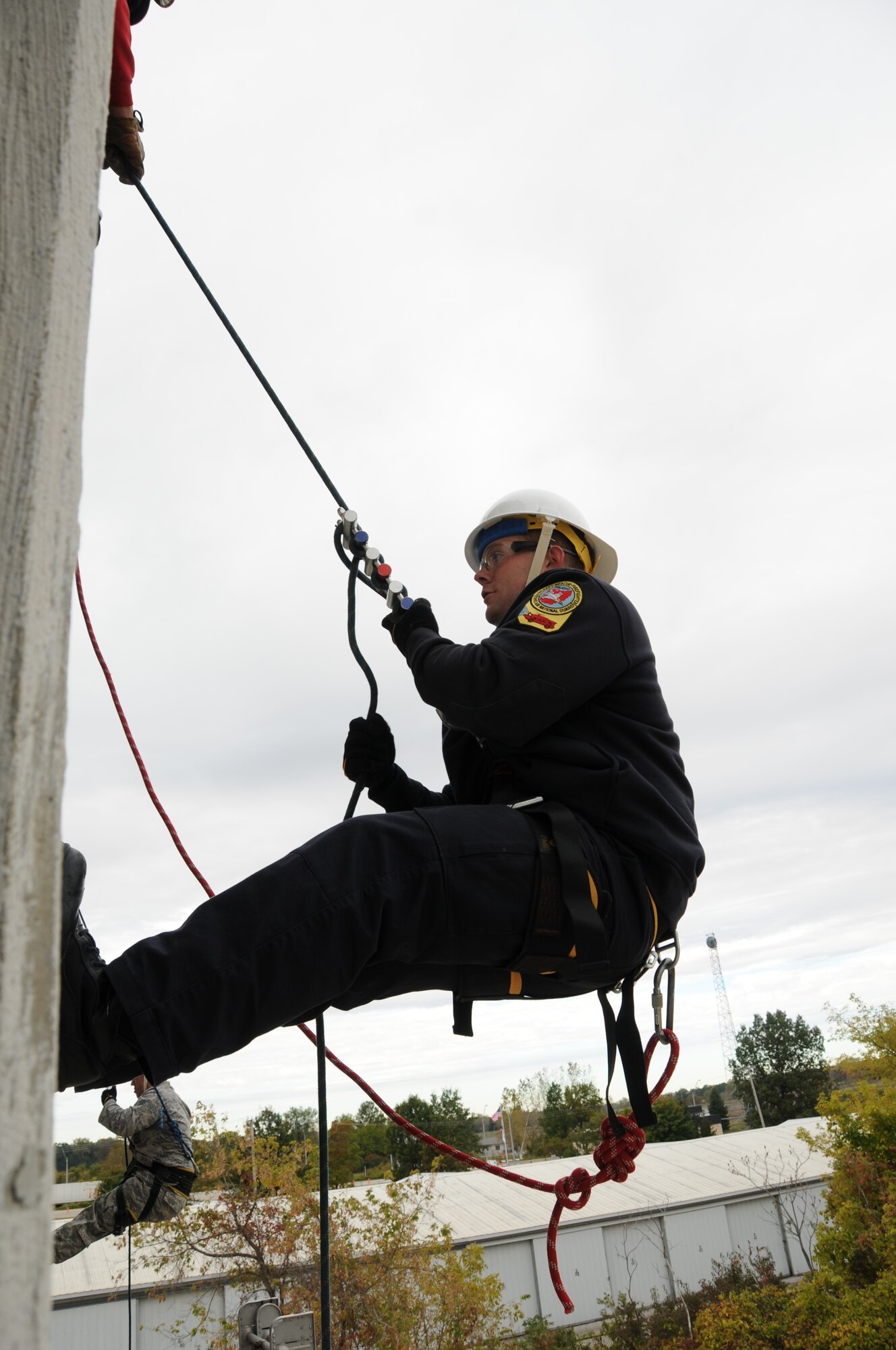 U.S. Air Force firefighters from the 180th Fighter Wing rappel down the side of a training facility at the Toledo Fire and Rescue Department Training Academy, October 5, 2010.  Firefighters from the 180th Fighter Wing are participating in six days of training designed to prepare them for various rescue situations. (U.S. Air Force photo by Senior Airman Amber Williams/Released)