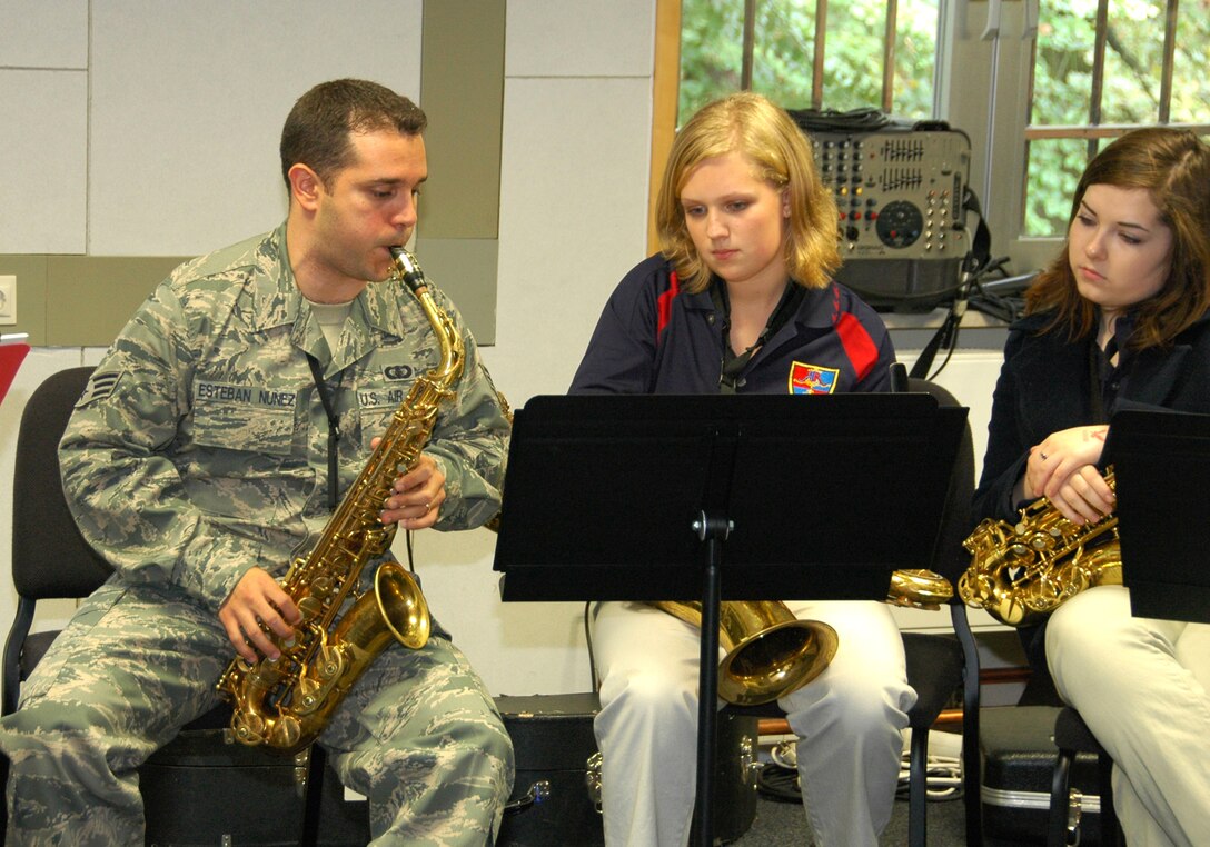 USAFE Band Saxophonist SrA Lencys Estaban-Nunez  demonstrates a musical passage for Elizabeth Watson and Emily McCormack from Ramstein High School.  The USAFE Band hosted 86 High School music students from Ramstein and Kaiserslautern High Schools during an inaugural music clinic at Sembach Air Base, Germany on 1 Oct 2010. (U.S. Air Force photo/Staff Sergeant Scott Ruedger)
