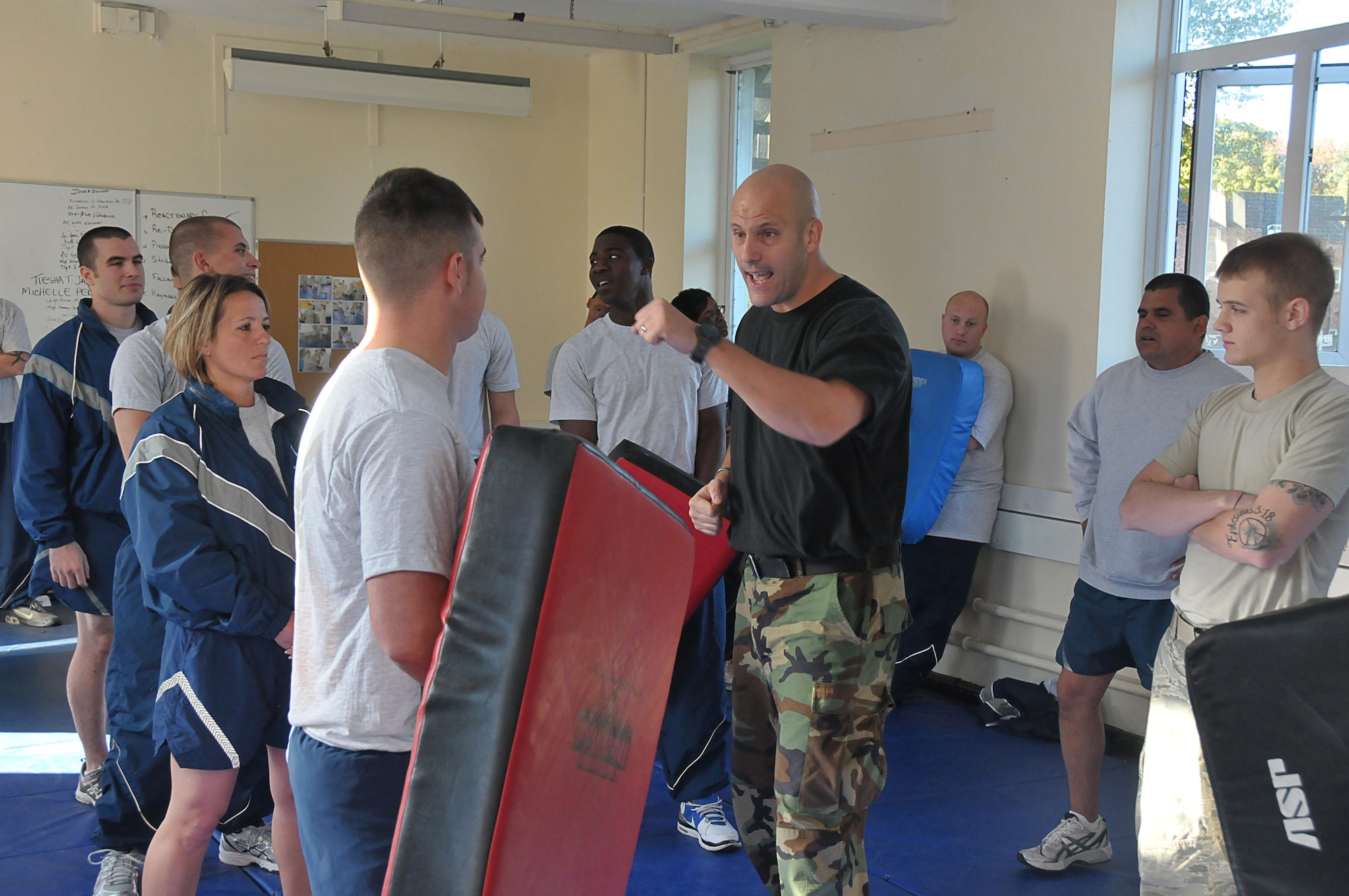 ROYAL AIR FORCE LAKENHEATH, England – Staff Sgt. Michael White, 48th Security Forces Squadron Instructor, demonstrates fist strikes during augmentee and combat skills training, Sept. 30 at RAF Fetwell. The augmentees will help Security Forces Squadron with base security when called upon during heightened Force Protection Condition levels for RAFs Lakenheath and Feltwell.  This is the first augmenter program initiated to help during low security forces manning.  (U.S. Air Force photo/Staff Sgt. Connor Estes)